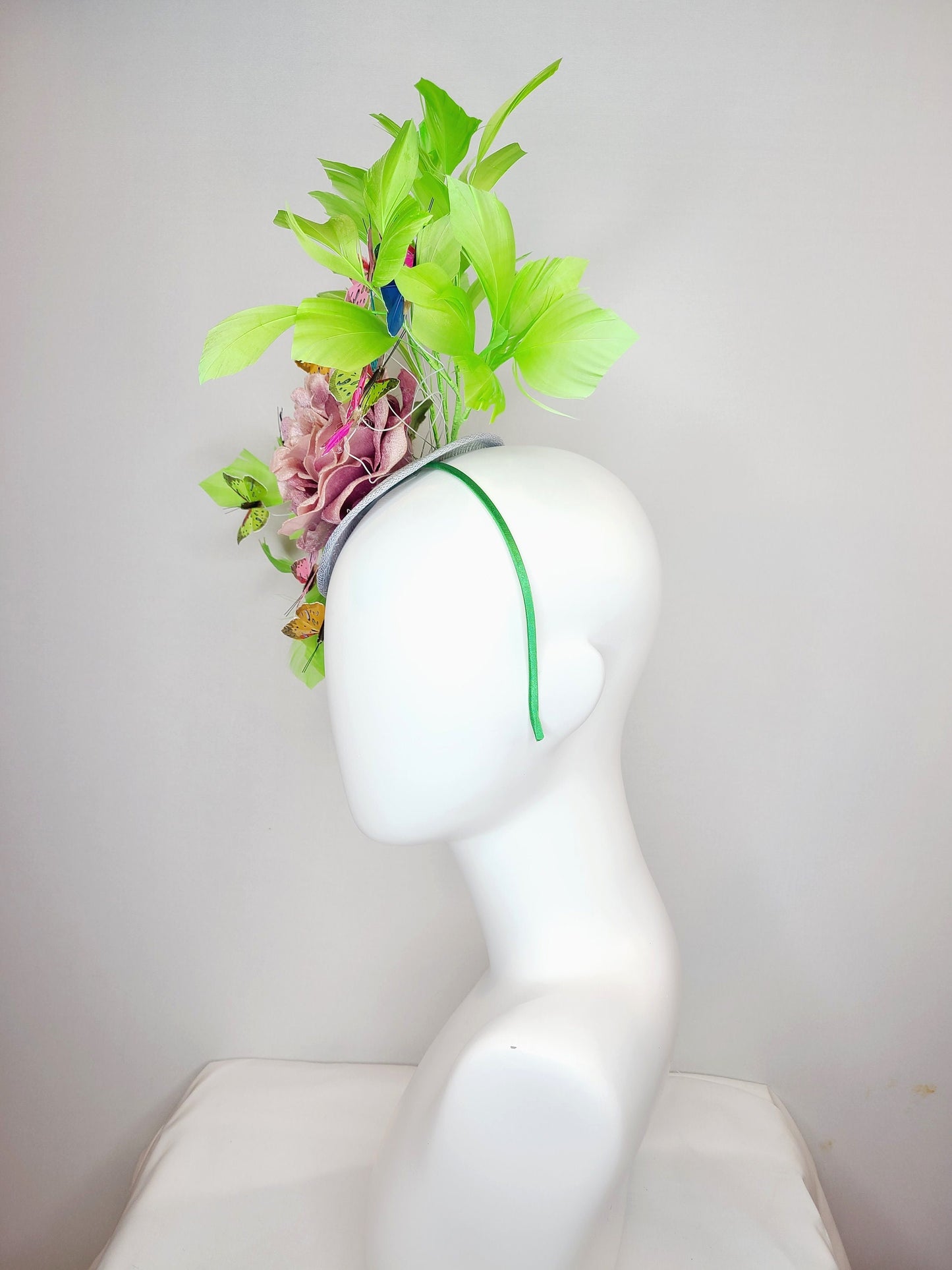kentucky derby hat fascinator bright green feathers with mauve light pink rose rainbow pink yellow green blue decor and butterflies