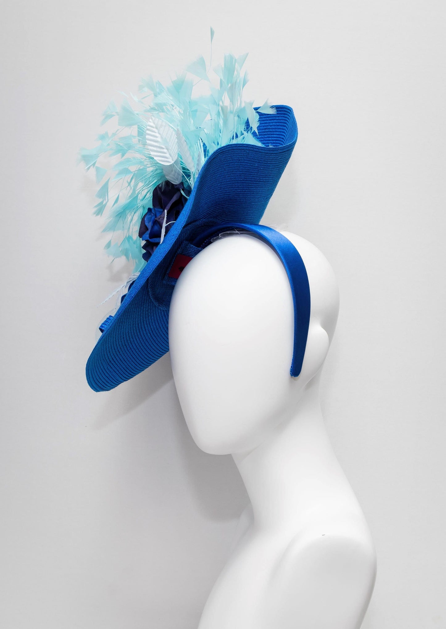 kentucky derby hat fascinator royal blue woven base with navy rose flower light blue leaves aqua turquoise blue feathers