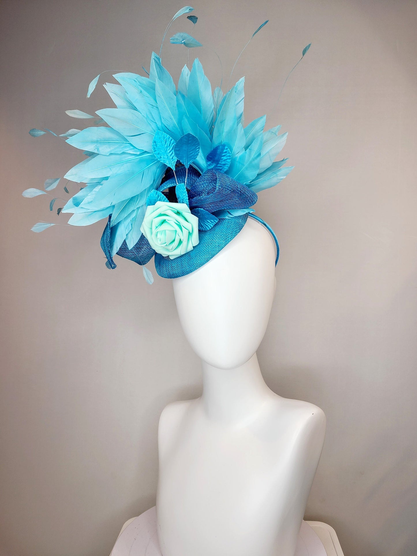 kentucky derby hat fascinator turquoise blue sinamay with bow and curls mint blue green rose blue leaves and blue aqua large feathers