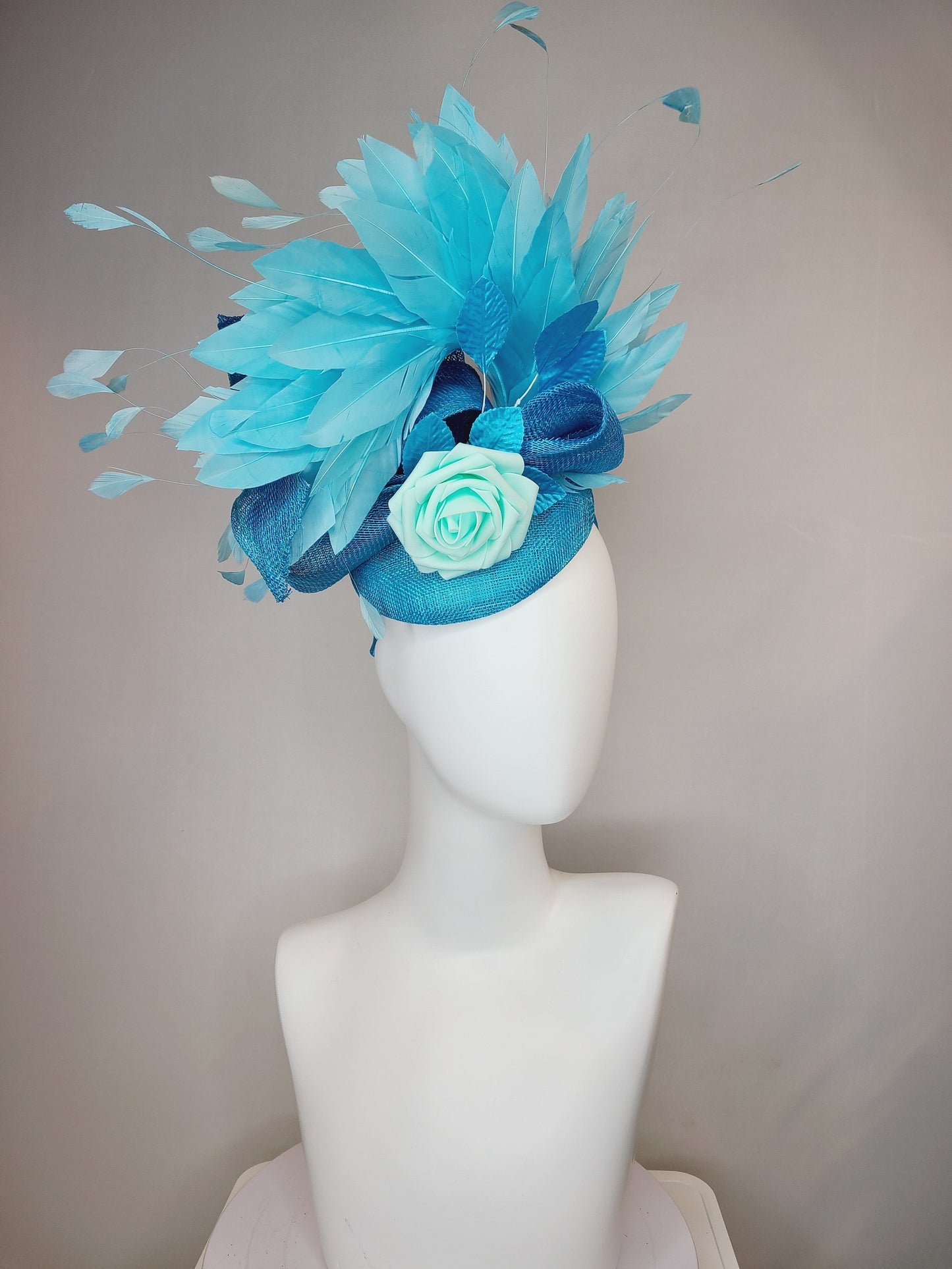 kentucky derby hat fascinator turquoise blue sinamay with bow and curls mint blue green rose blue leaves and blue aqua large feathers