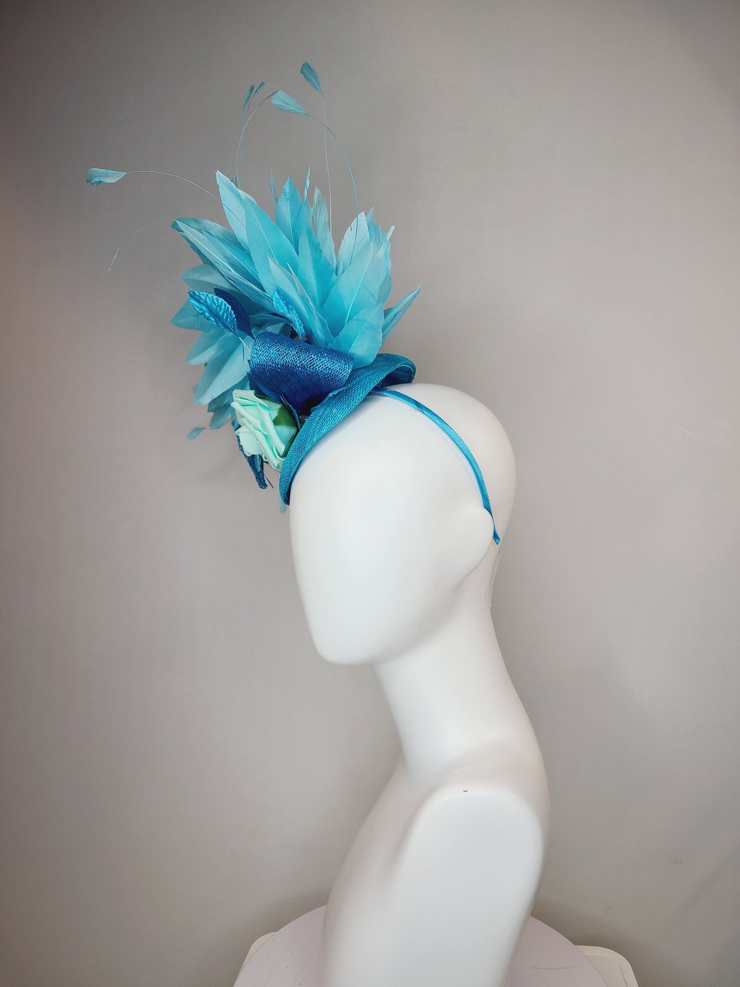 kentucky derby hat fascinator turquoise blue sinamay with bow and curls mint blue green rose blue leaves and blue aqua large feathers