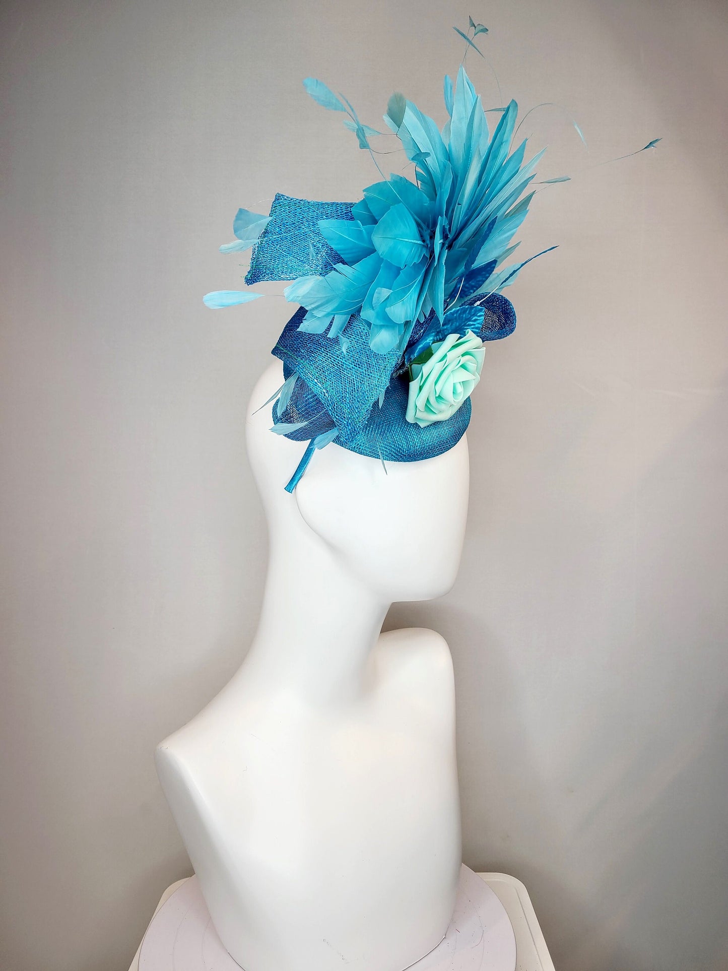 kentucky derby hat fascinator turquoise blue sinamay with bow and curls mint blue green rose blue leaves and blue aqua large feathers