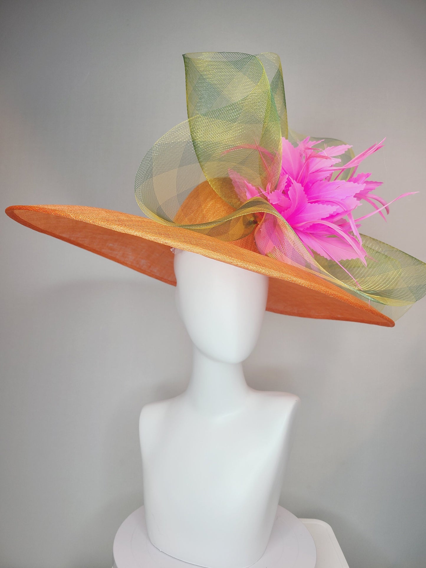 kentucky derby hat large wide brim sinamay orange hat with large pink feather pouf decor with green gingham plaid crinoline