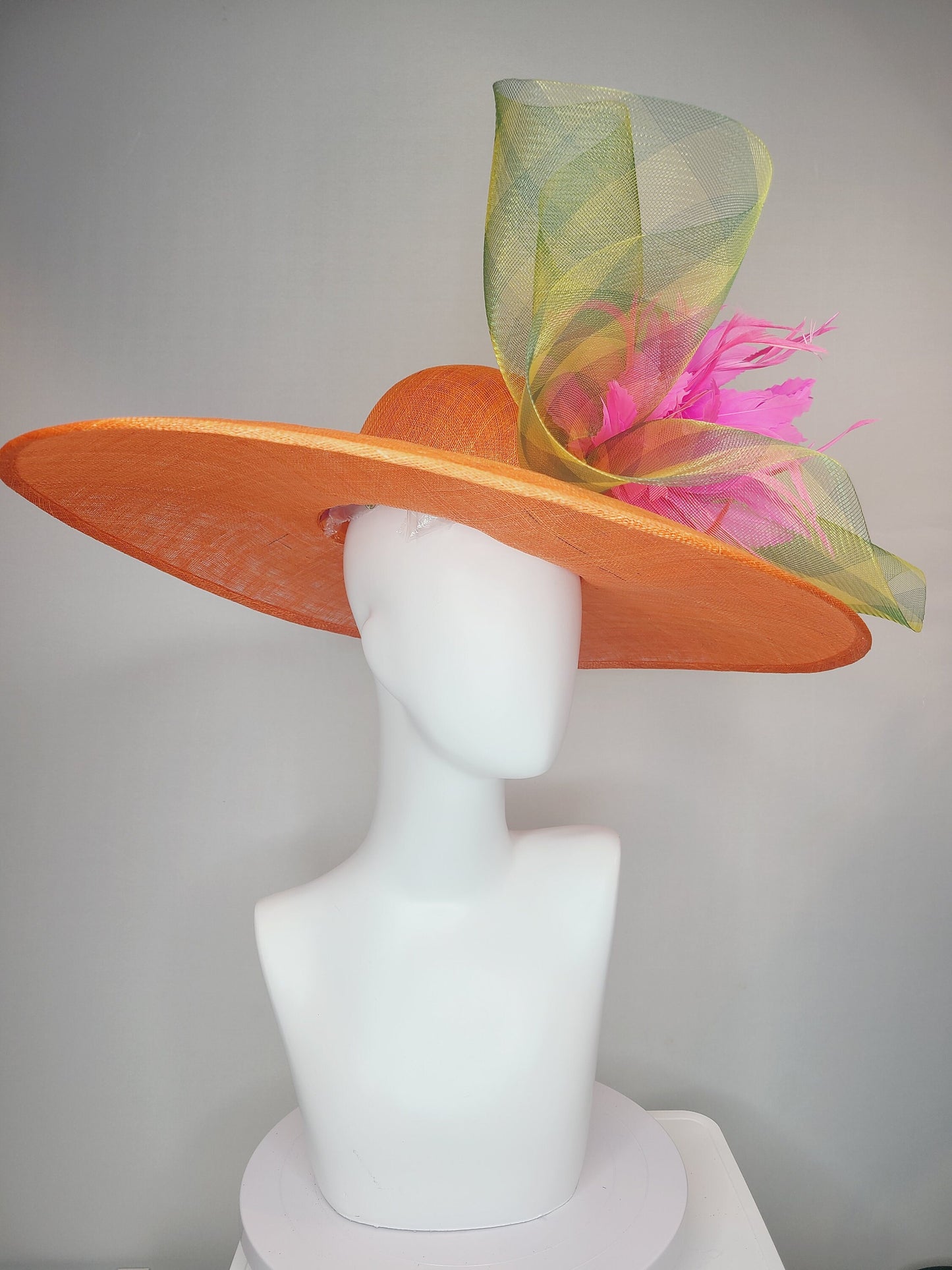 kentucky derby hat large wide brim sinamay orange hat with large pink feather pouf decor with green gingham plaid crinoline