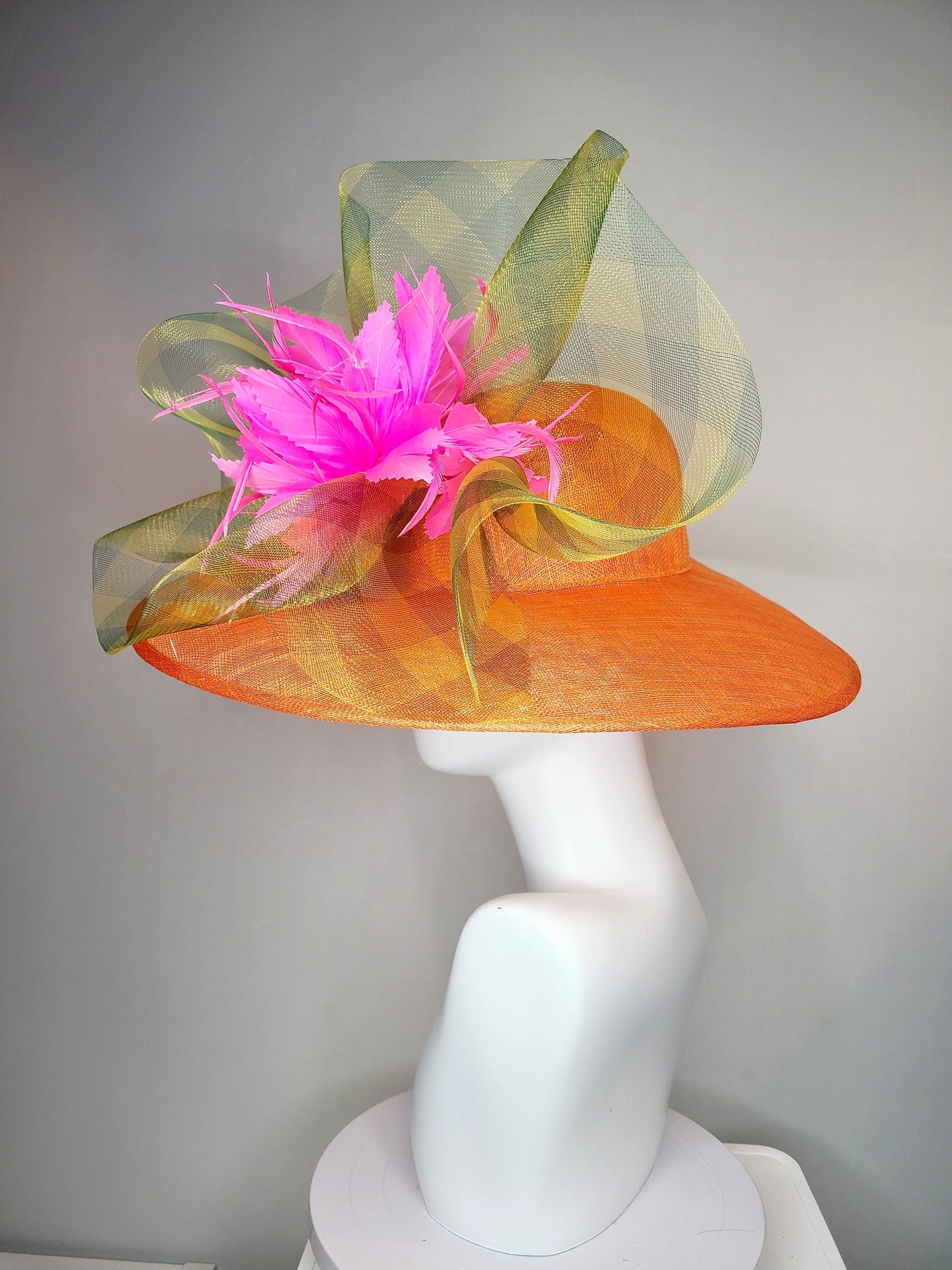 kentucky derby hat large wide brim sinamay orange hat with large pink feather pouf decor with green gingham plaid crinoline