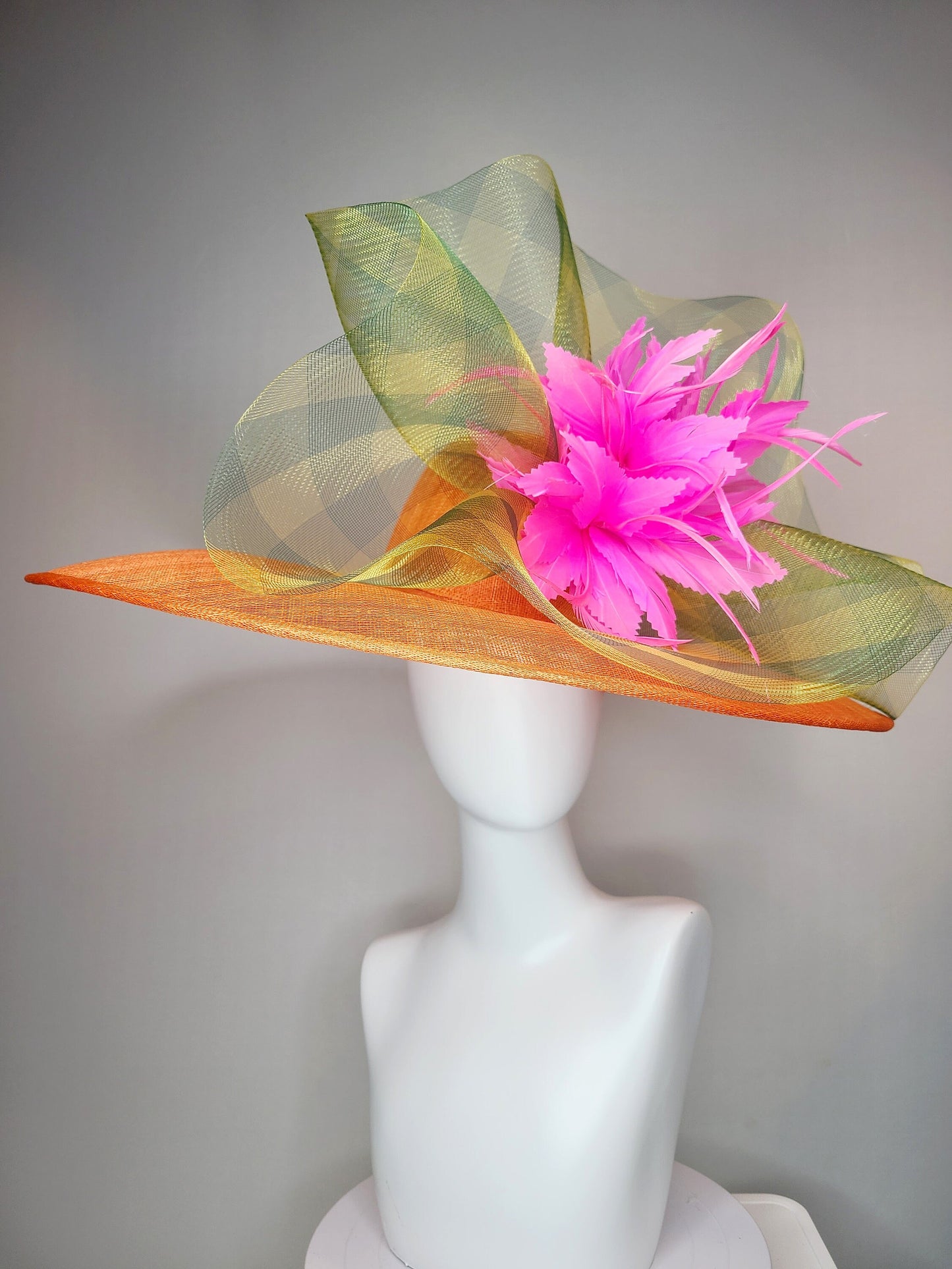 kentucky derby hat large wide brim sinamay orange hat with large pink feather pouf decor with green gingham plaid crinoline
