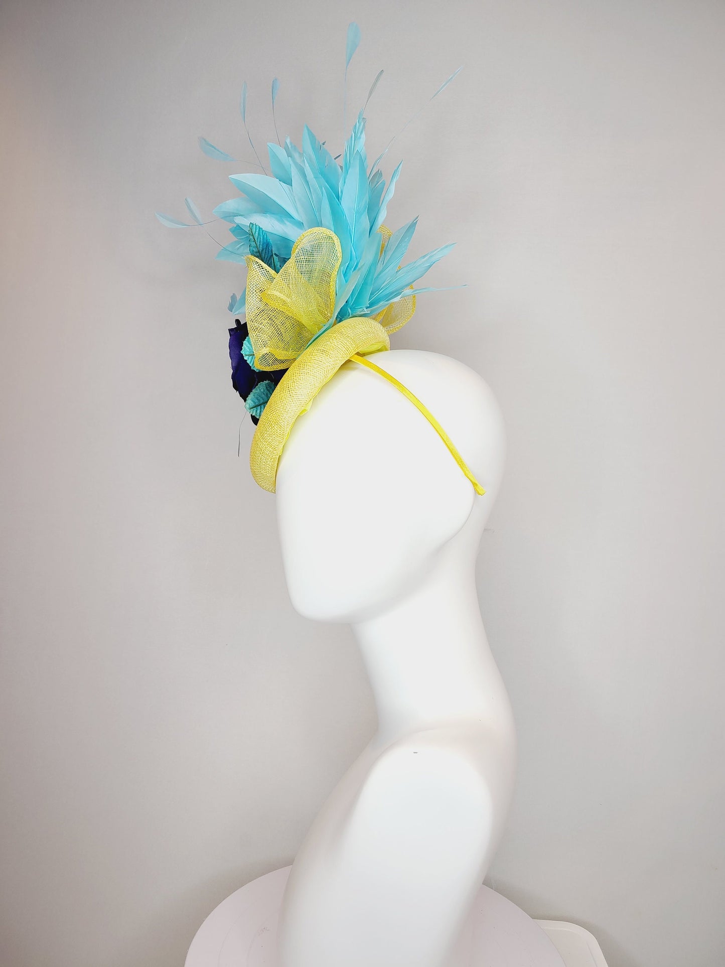 kentucky derby hat fascinator yellow sinamay with aqua blue feathers with navy dark royal blue rose flower teal leaves
