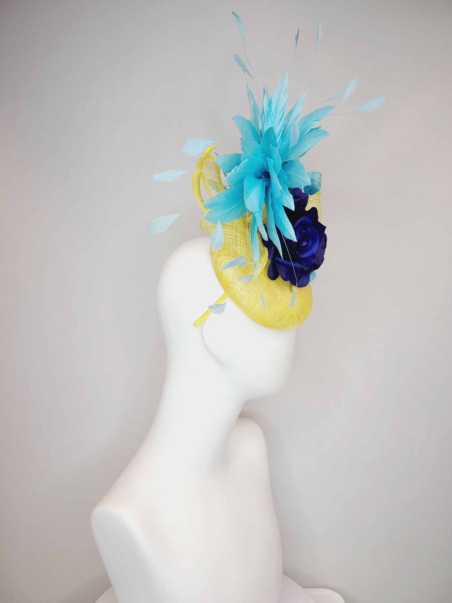 kentucky derby hat fascinator yellow sinamay with aqua blue feathers with navy dark royal blue rose flower teal leaves