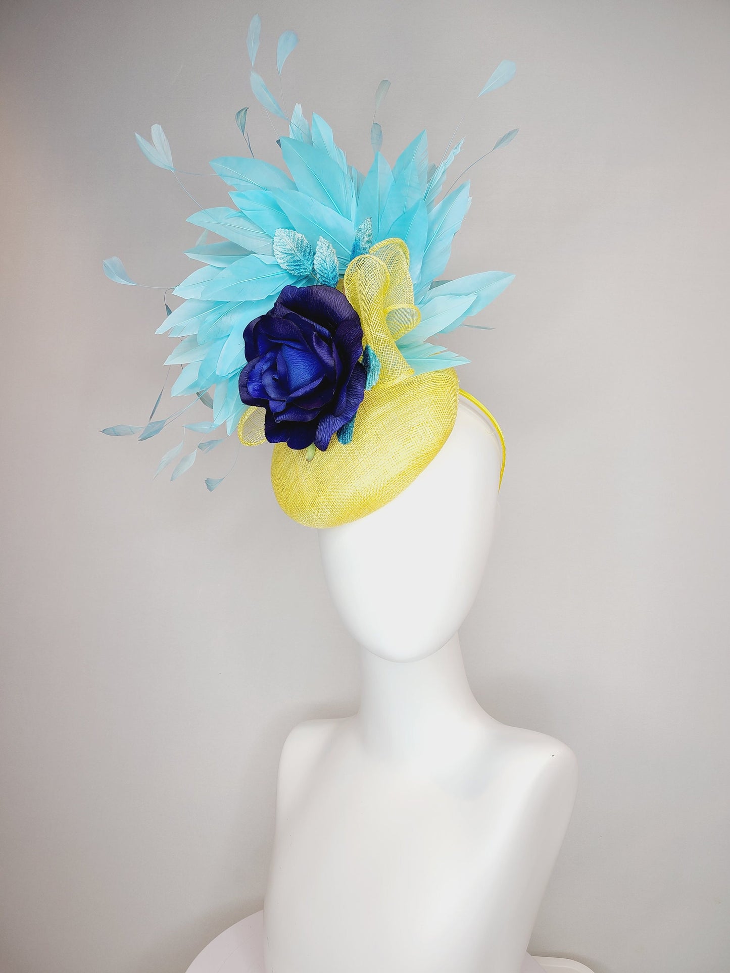 kentucky derby hat fascinator yellow sinamay with aqua blue feathers with navy dark royal blue rose flower teal leaves