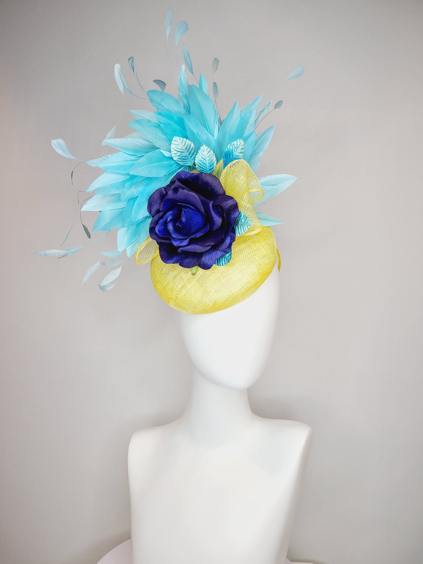kentucky derby hat fascinator yellow sinamay with aqua blue feathers with navy dark royal blue rose flower teal leaves