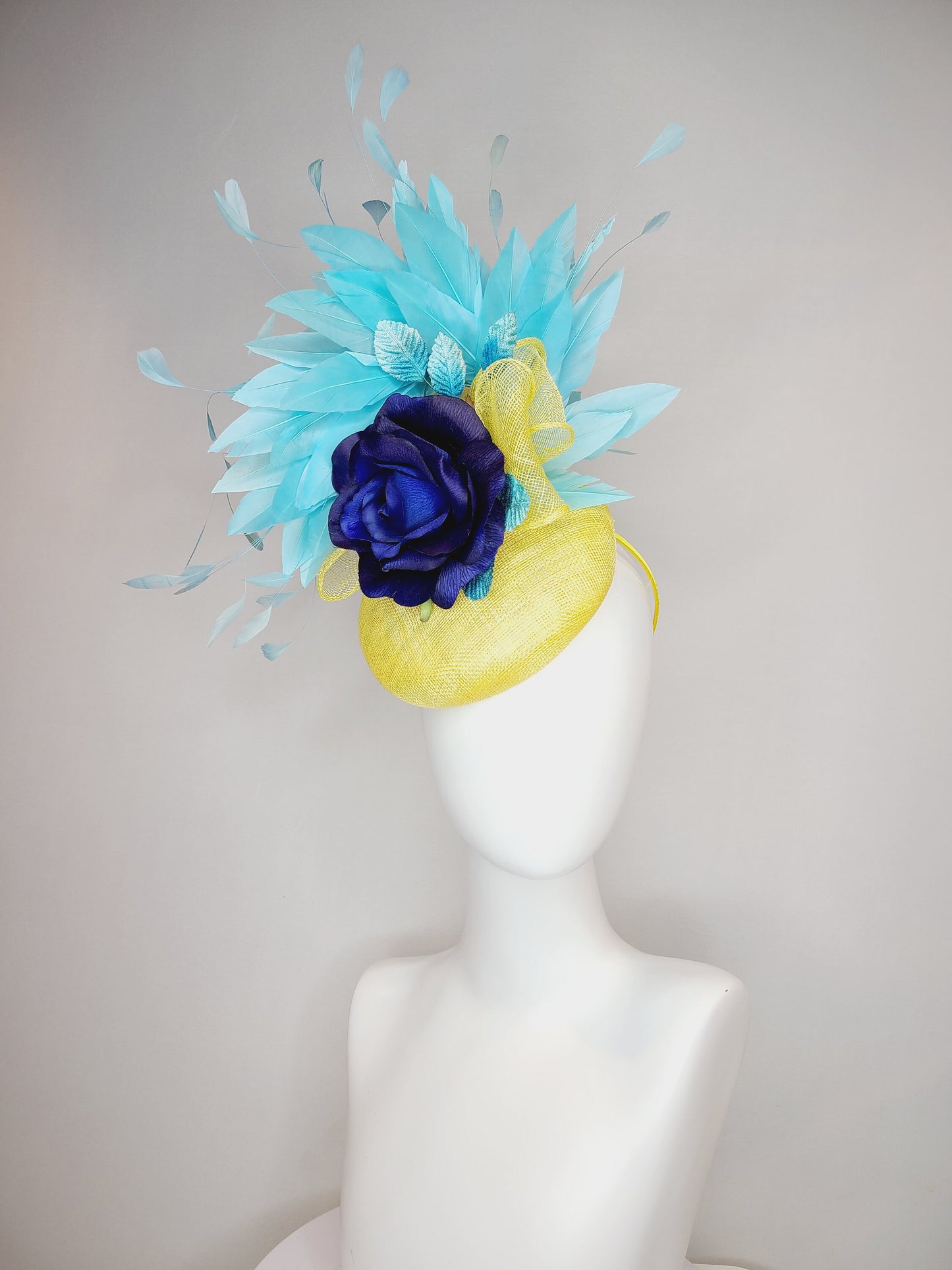 kentucky derby hat fascinator yellow sinamay with aqua blue feathers with navy dark royal blue rose flower teal leaves