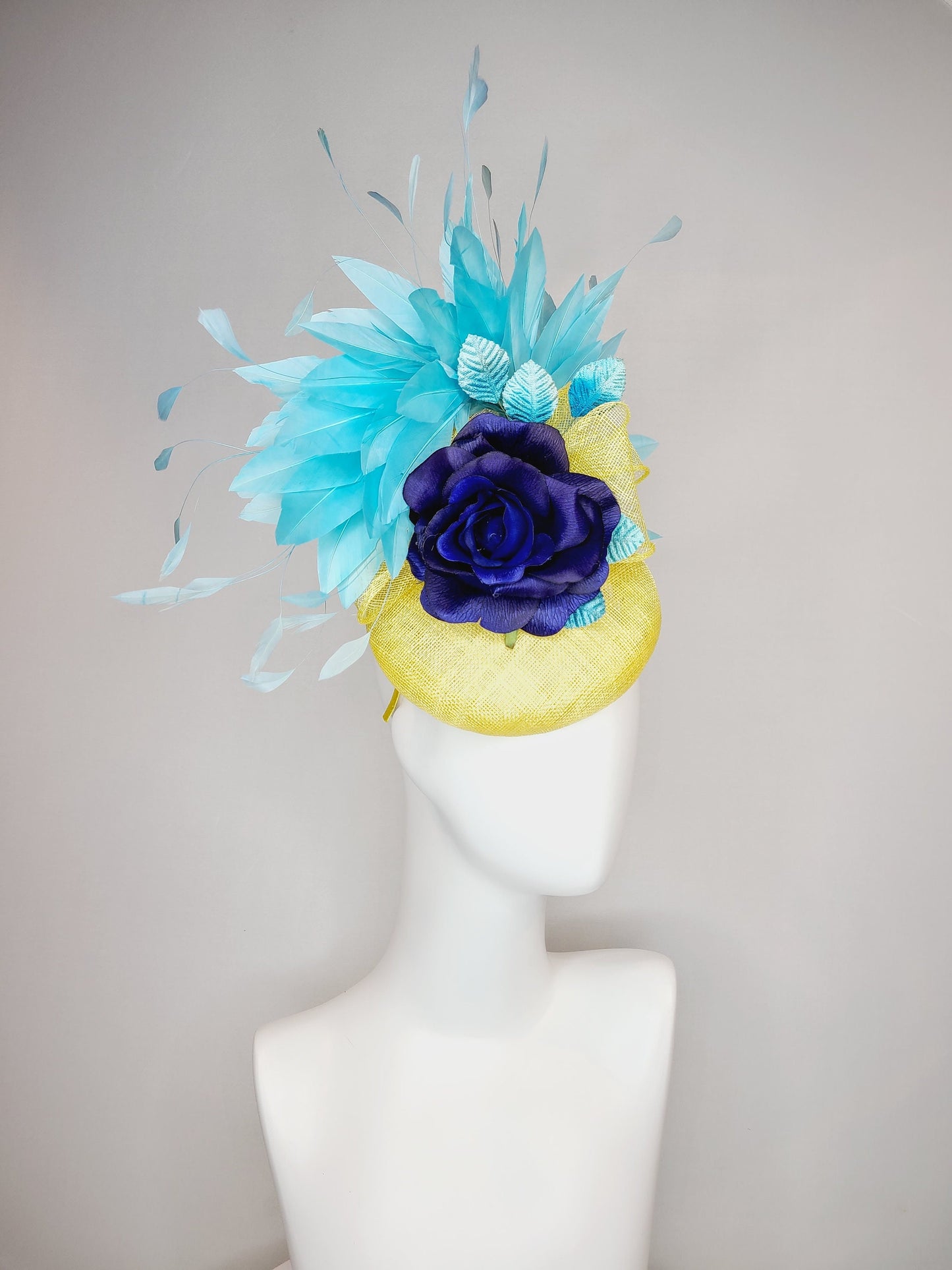 kentucky derby hat fascinator yellow sinamay with aqua blue feathers with navy dark royal blue rose flower teal leaves