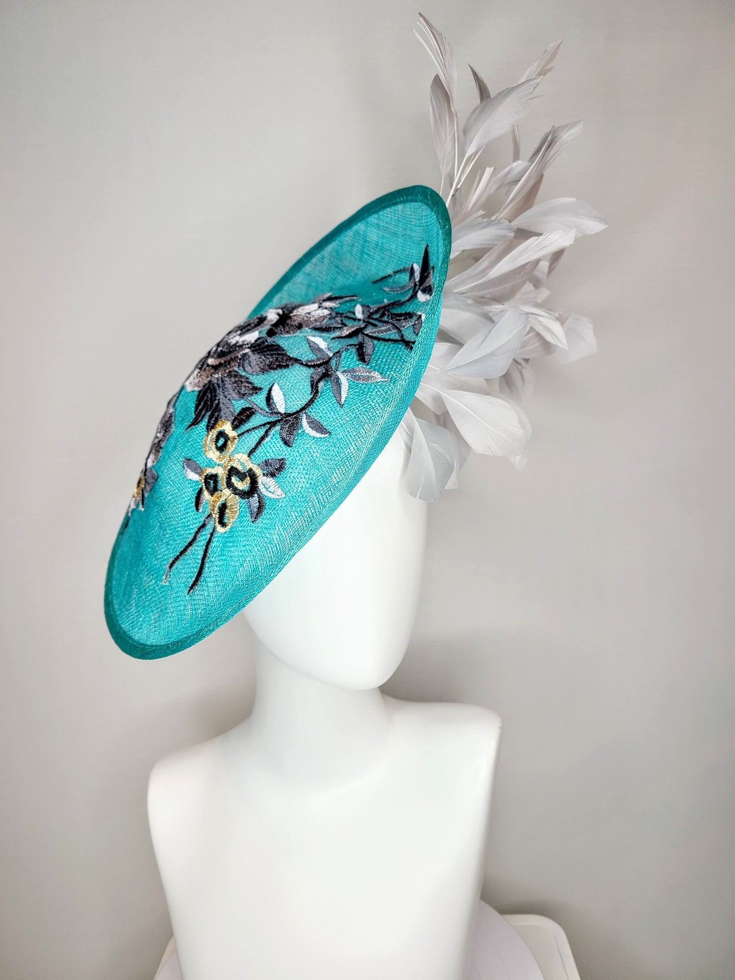 kentucky derby hat fascinator teal blue green sinamay saucer with silver gray black embroidered flowers with silver gray feathers