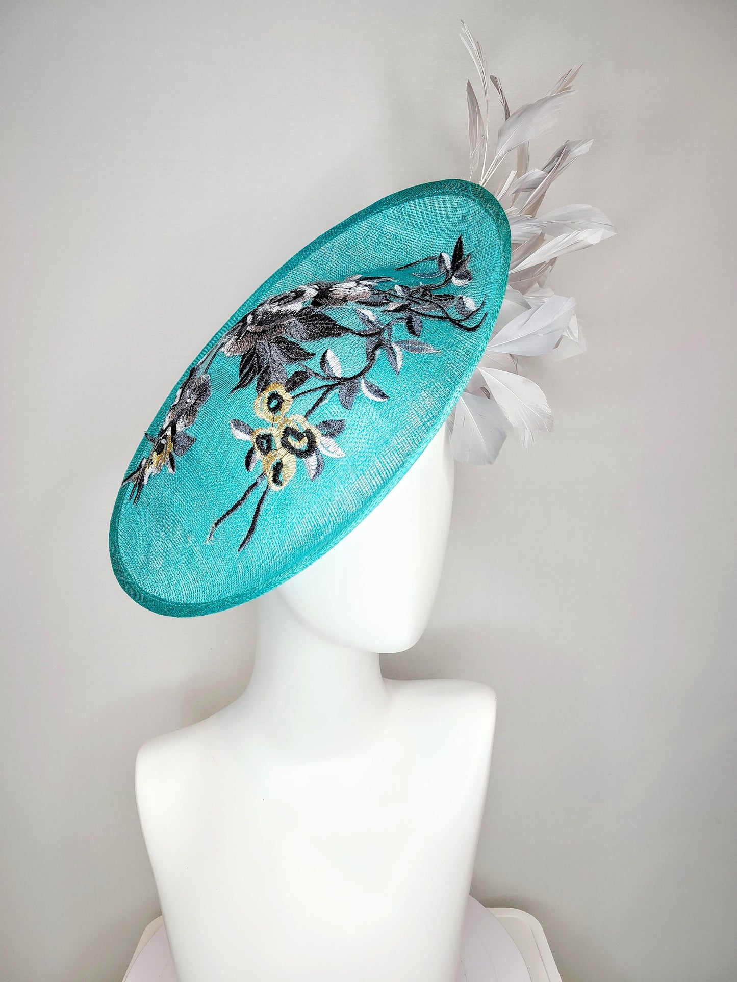 kentucky derby hat fascinator teal blue green sinamay saucer with silver gray black embroidered flowers with silver gray feathers