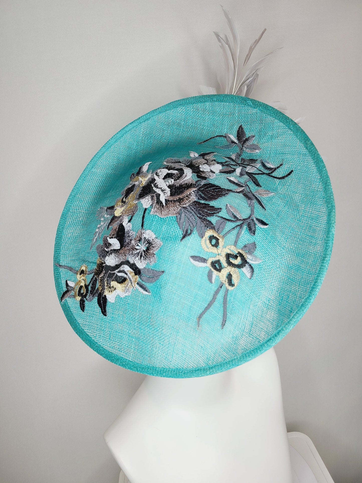kentucky derby hat fascinator teal blue green sinamay saucer with silver gray black embroidered flowers with silver gray feathers
