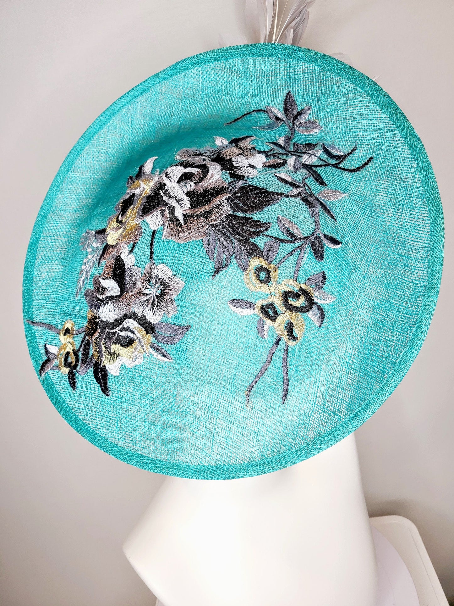kentucky derby hat fascinator teal blue green sinamay saucer with silver gray black embroidered flowers with silver gray feathers