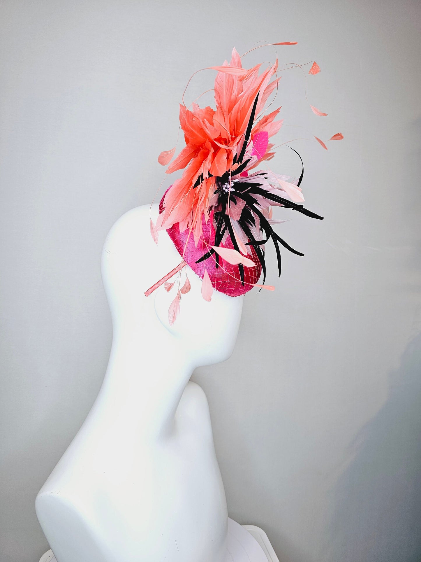 kentucky derby hat fascinator bright pink satin fascinator with light pink and black feather flower coral orange feathers