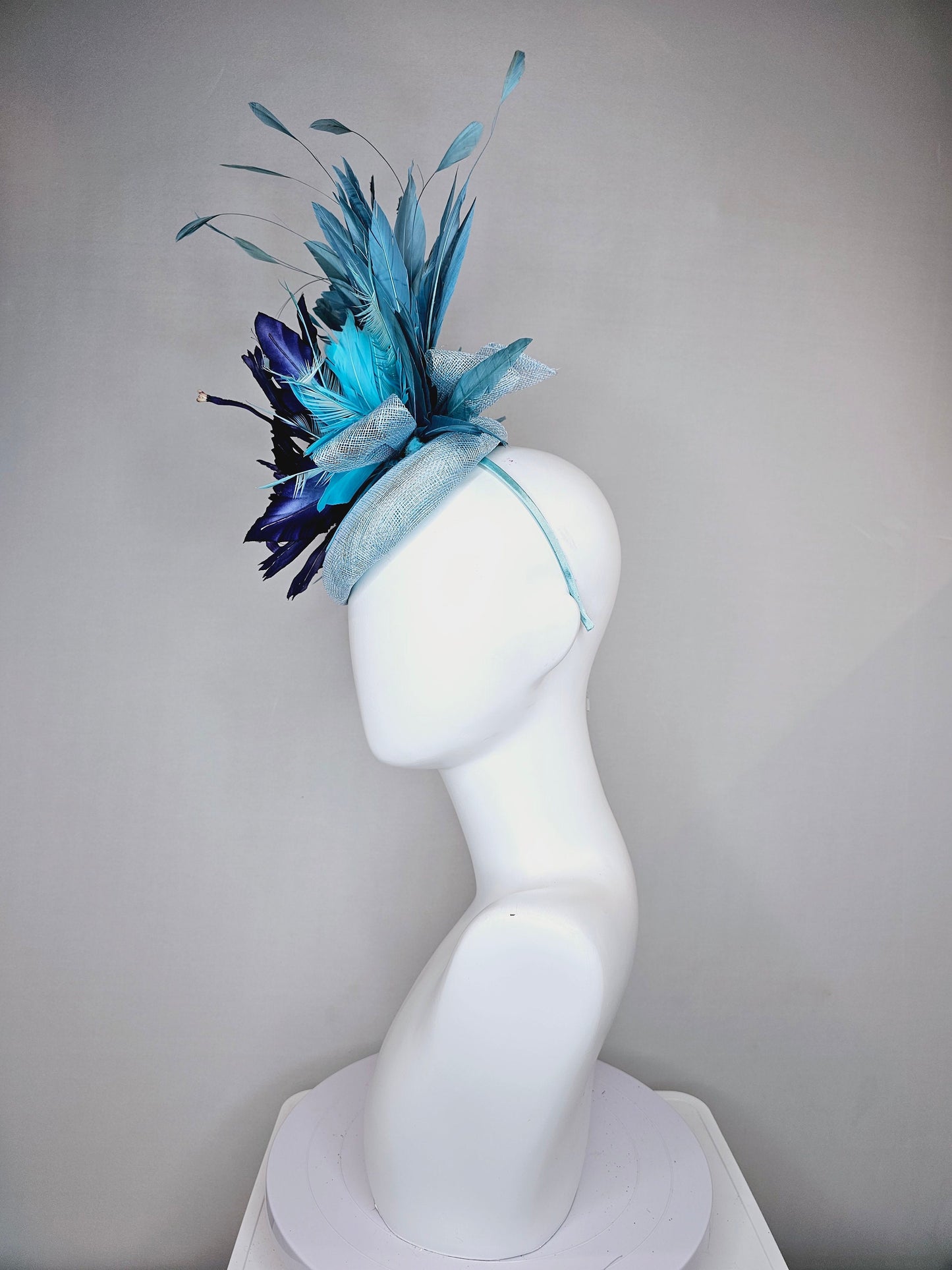 kentucky derby hat fascinator light blue sinamay base with blue navy satin large flower aqua turquoise blue feathers