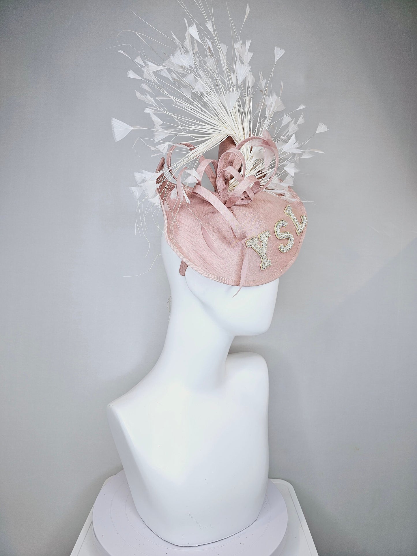 kentucky derby hat fascinator dusty rose blush silk like saucer with white feathers and beaded pearl letters