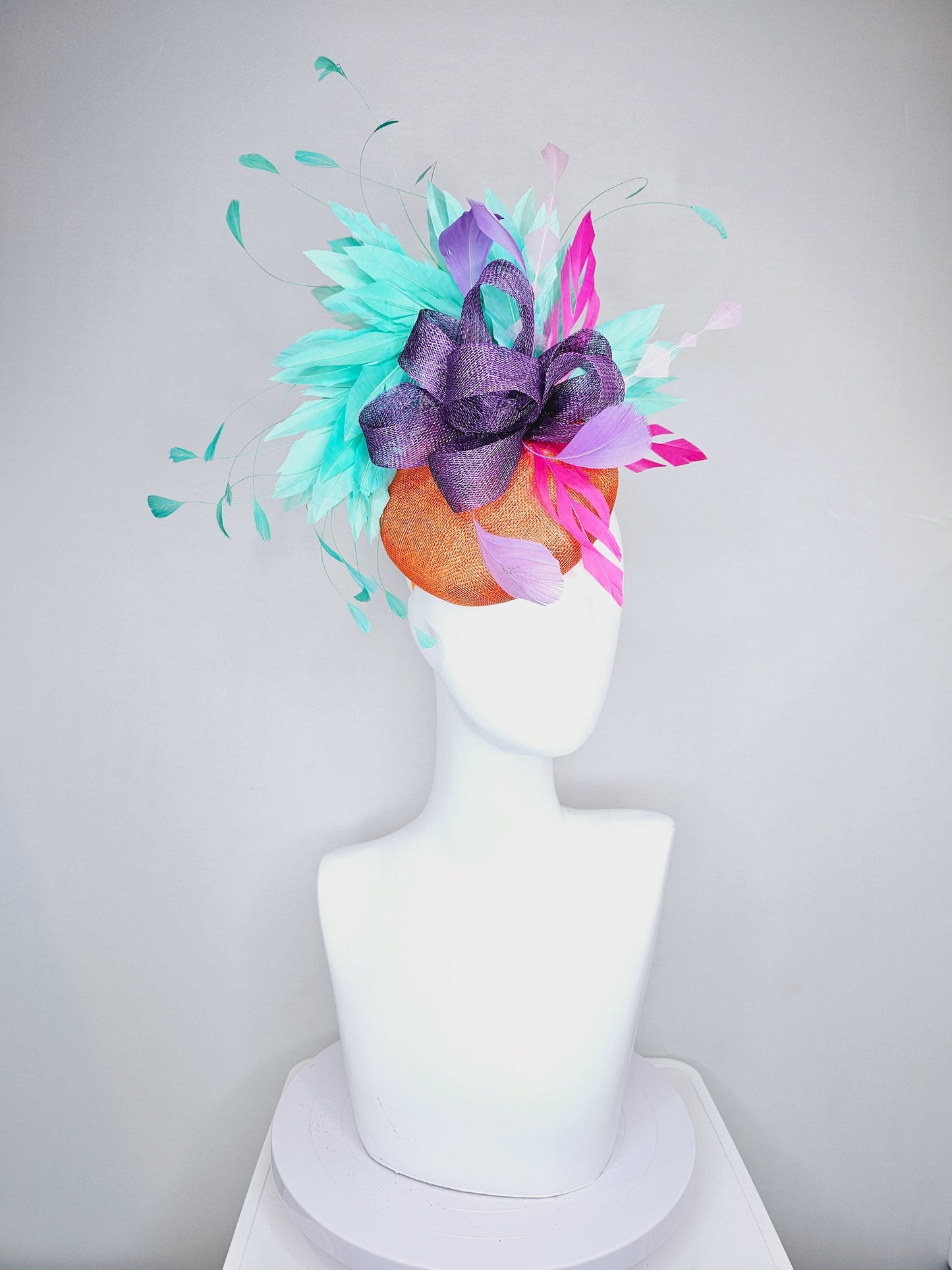 kentucky derby hat fascinator orange sinamay with mint green feathers with purple sinamay bow and hot pink feather accent