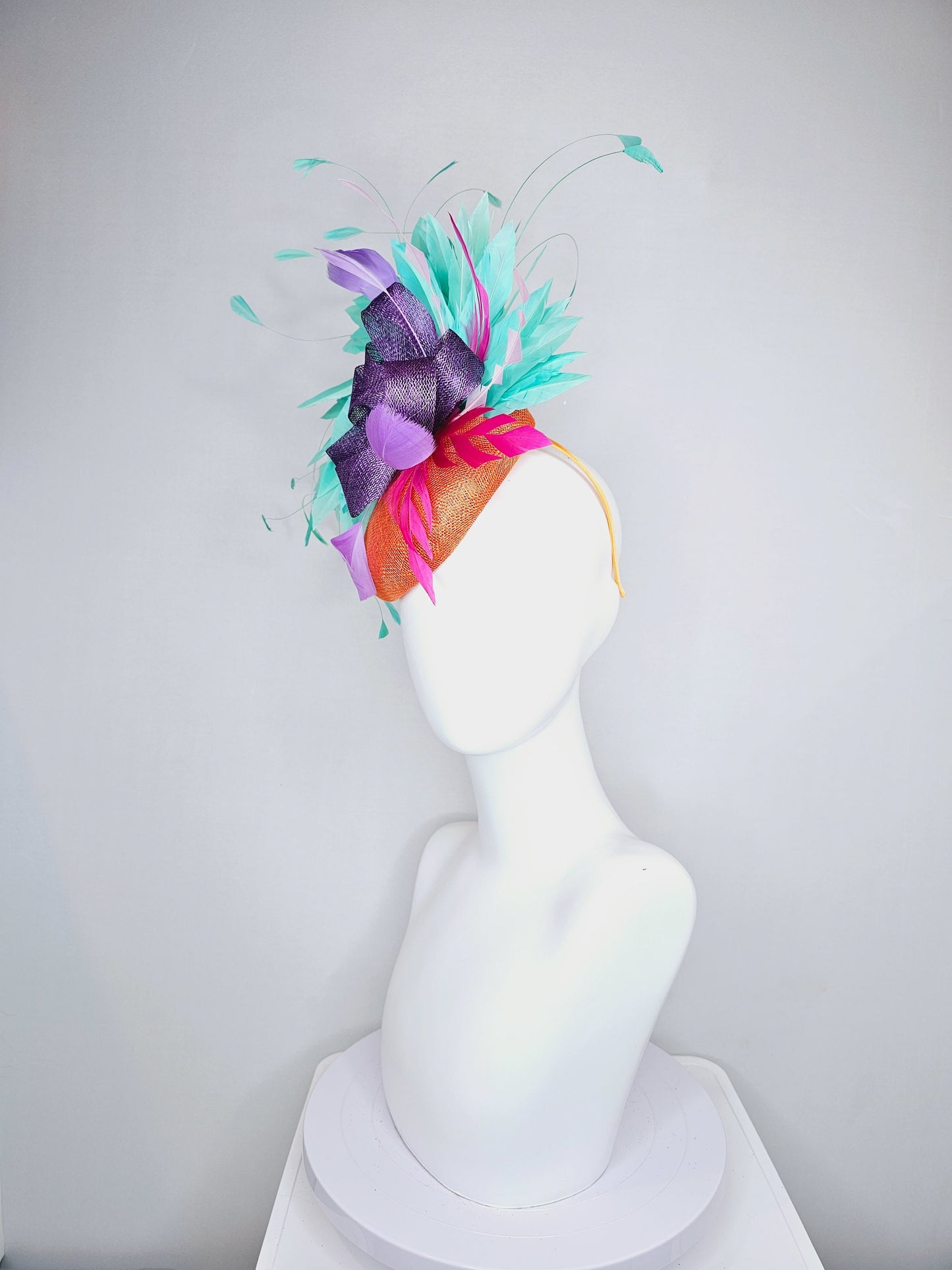 kentucky derby hat fascinator orange sinamay with mint green feathers with purple sinamay bow and hot pink feather accent