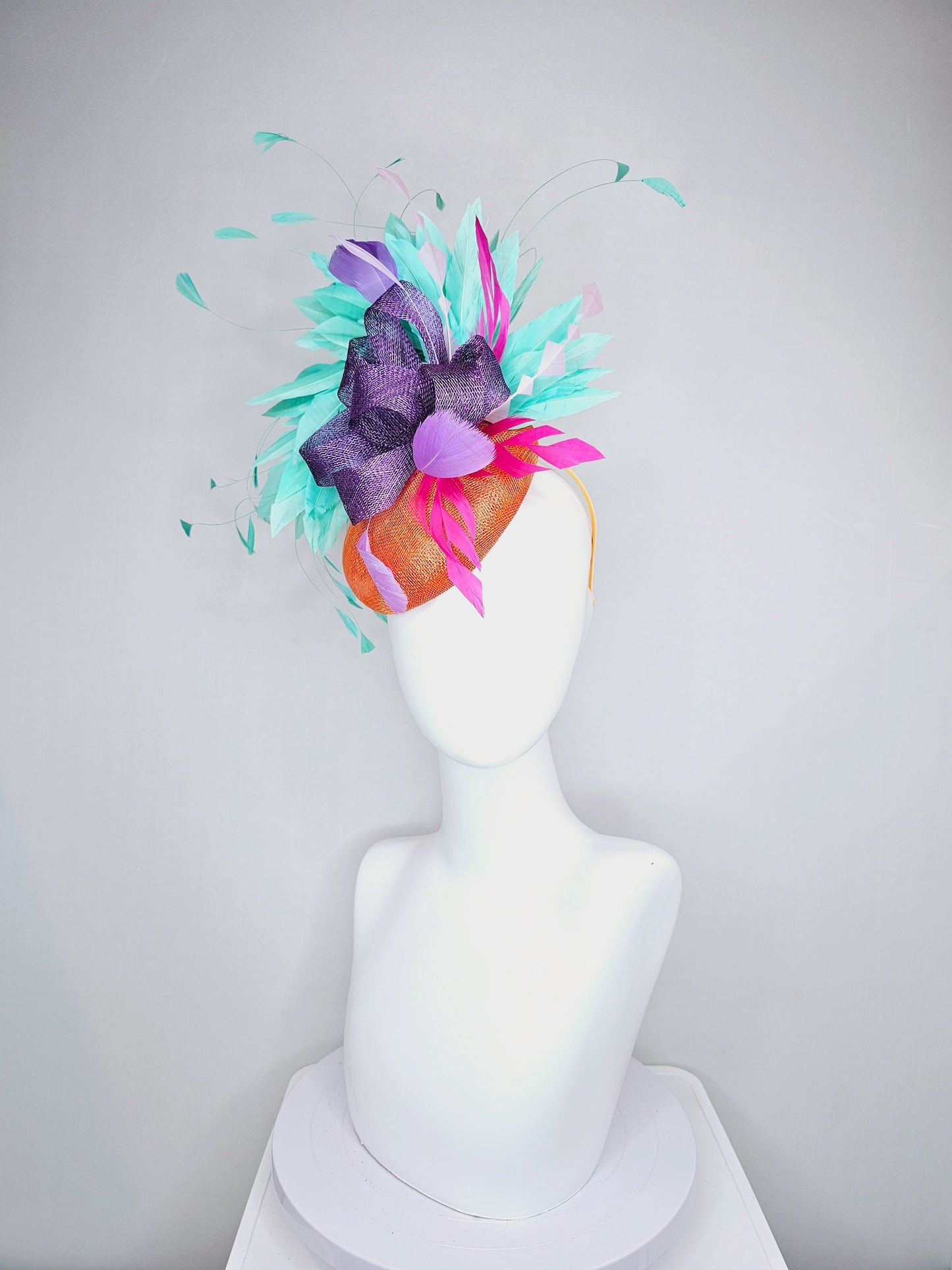 kentucky derby hat fascinator orange sinamay with mint green feathers with purple sinamay bow and hot pink feather accent