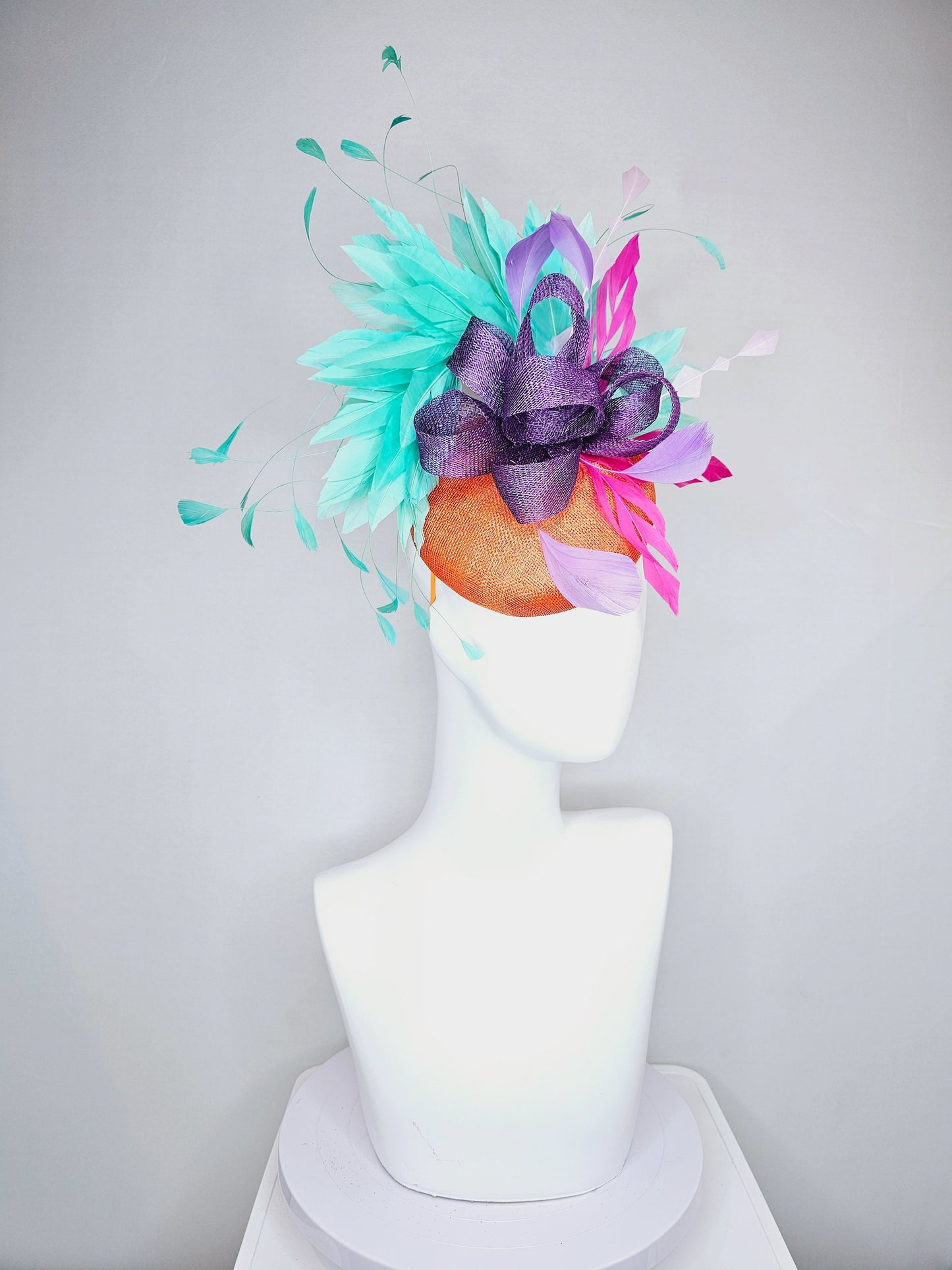 kentucky derby hat fascinator orange sinamay with mint green feathers with purple sinamay bow and hot pink feather accent