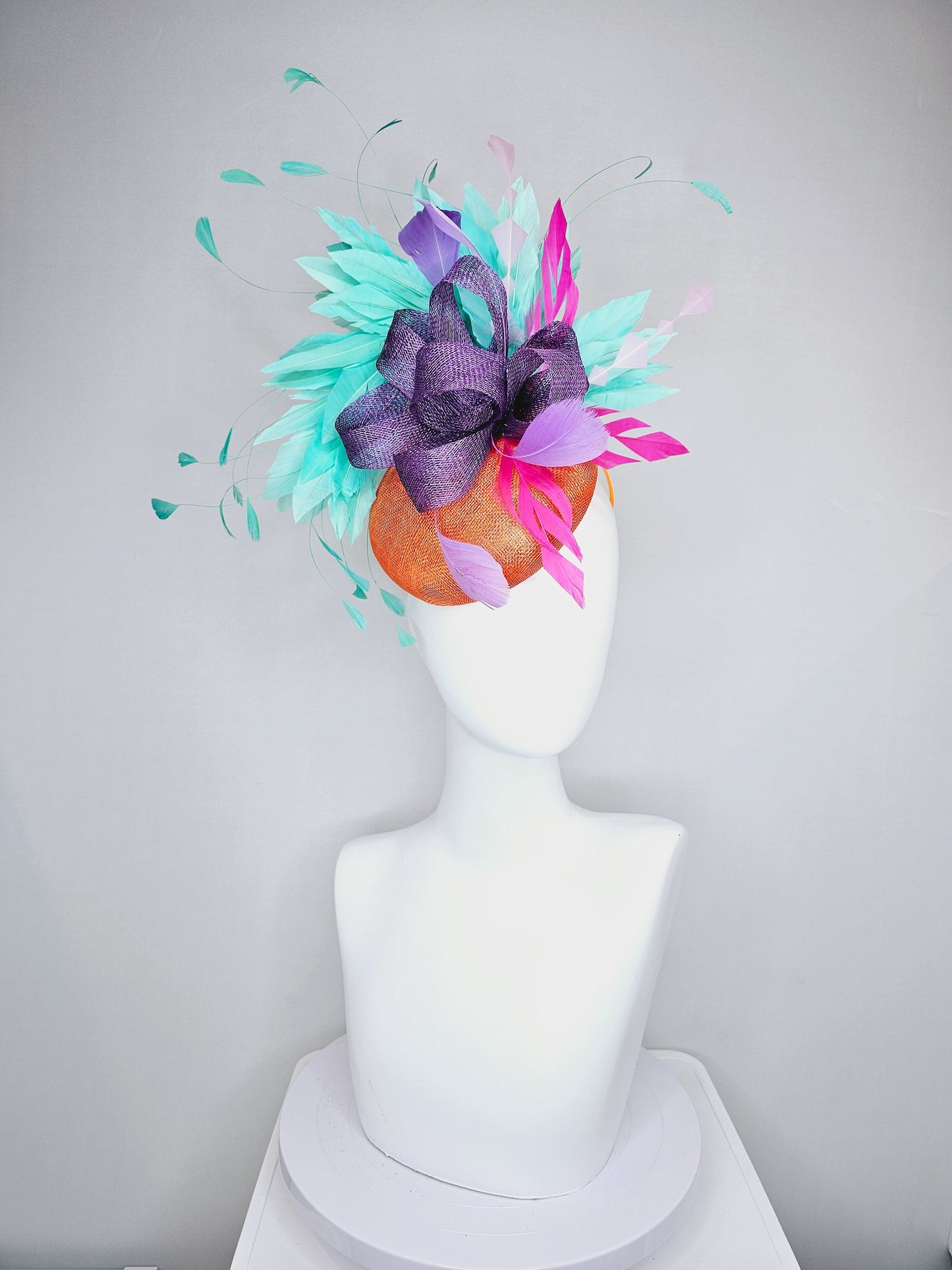 kentucky derby hat fascinator orange sinamay with mint green feathers with purple sinamay bow and hot pink feather accent