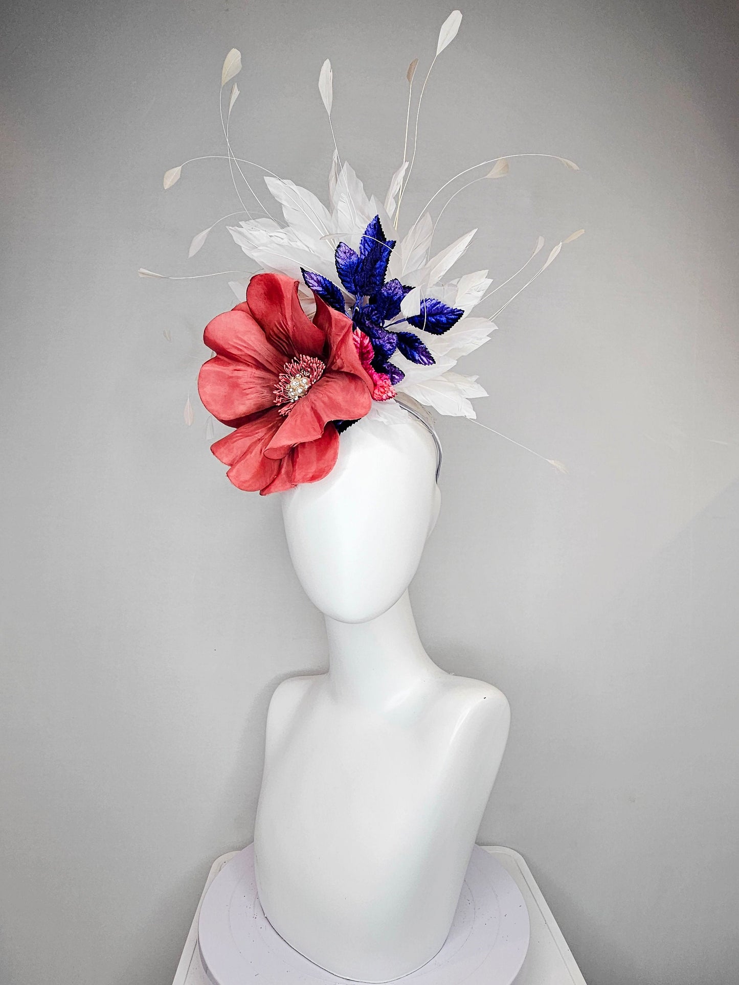 kentucky derby hat fascinator hat coral sinamay base large coral burnt orange flower with white feathers purple royal blue pink leaves