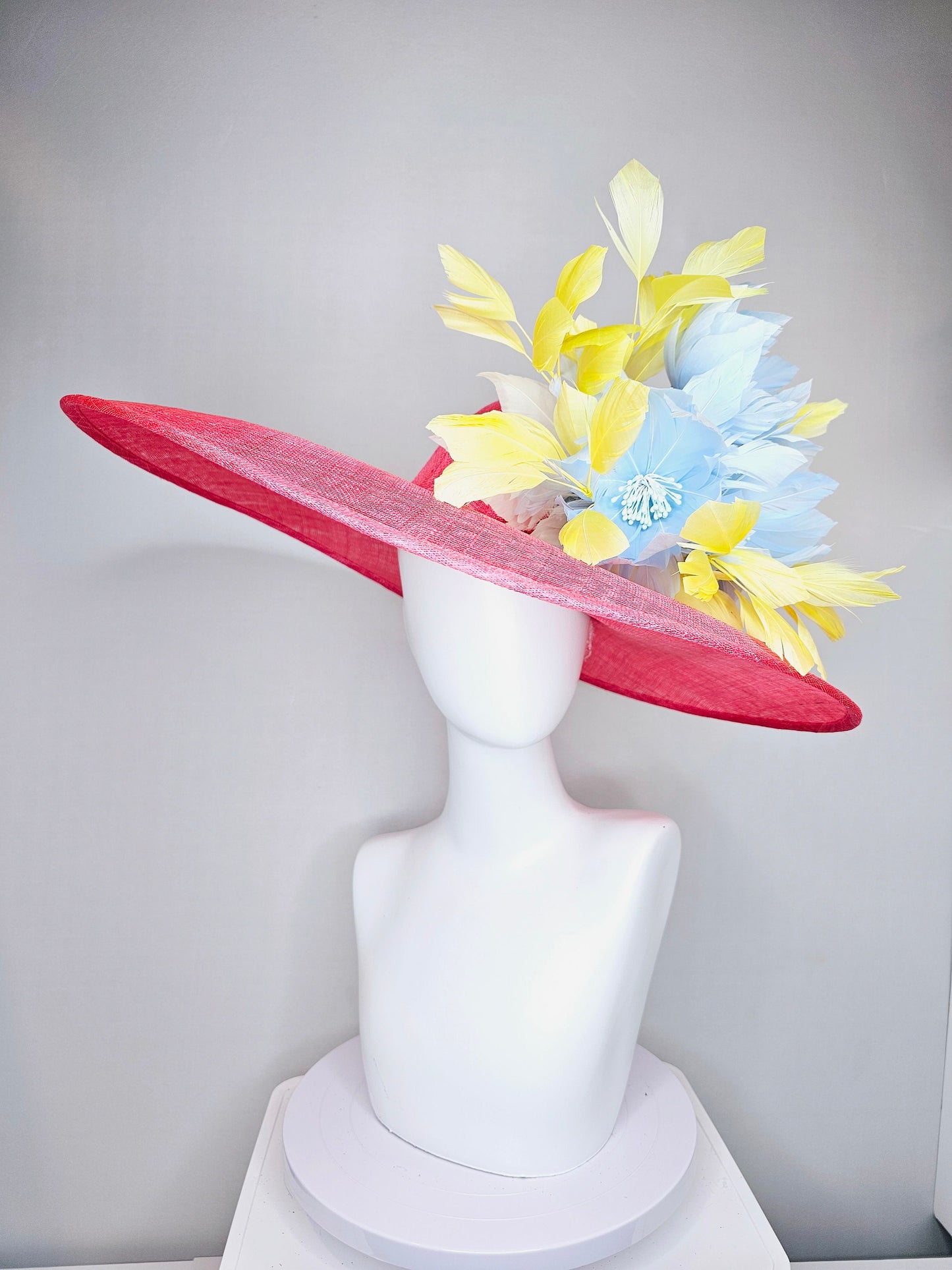 kentucky derby hat large wide brim sinamay coral pink hat with yellow feathers light blue fluffy feather flowers