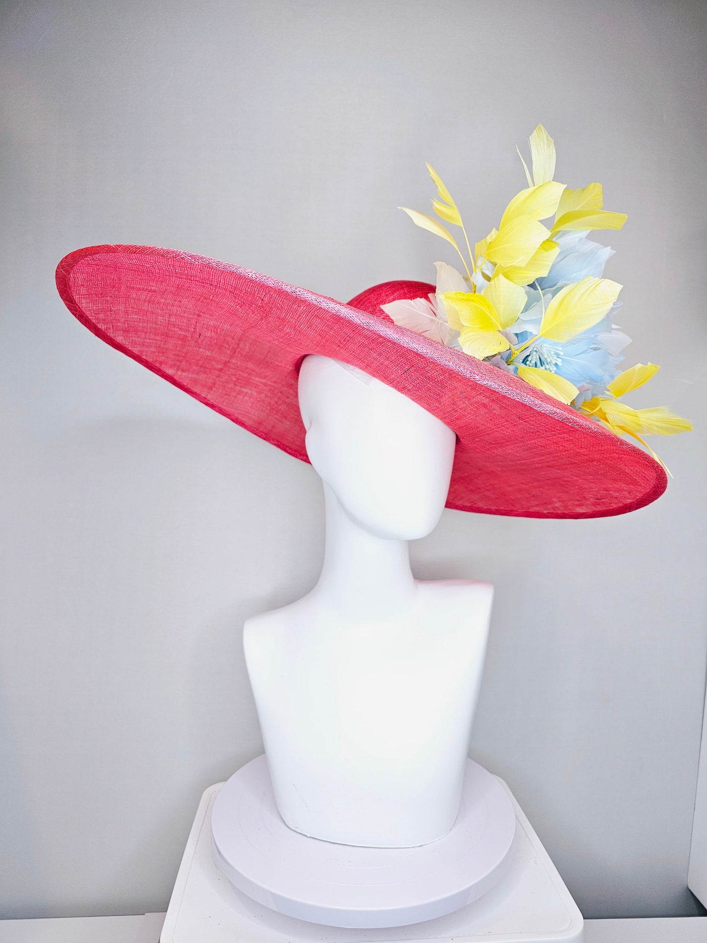 kentucky derby hat large wide brim sinamay coral pink hat with yellow feathers light blue fluffy feather flowers