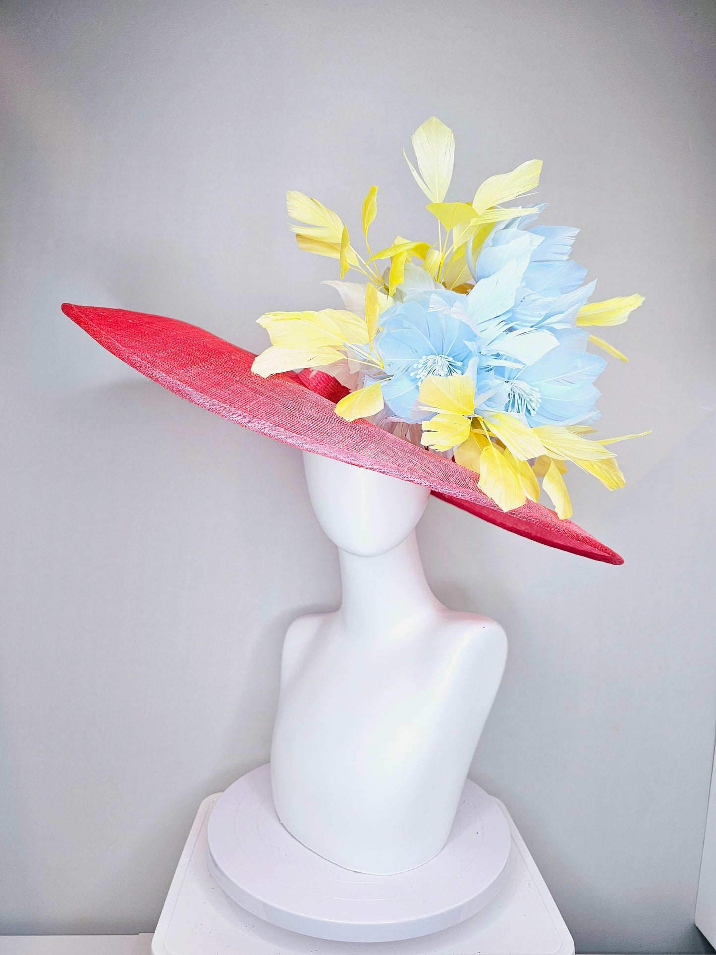 kentucky derby hat large wide brim sinamay coral pink hat with yellow feathers light blue fluffy feather flowers