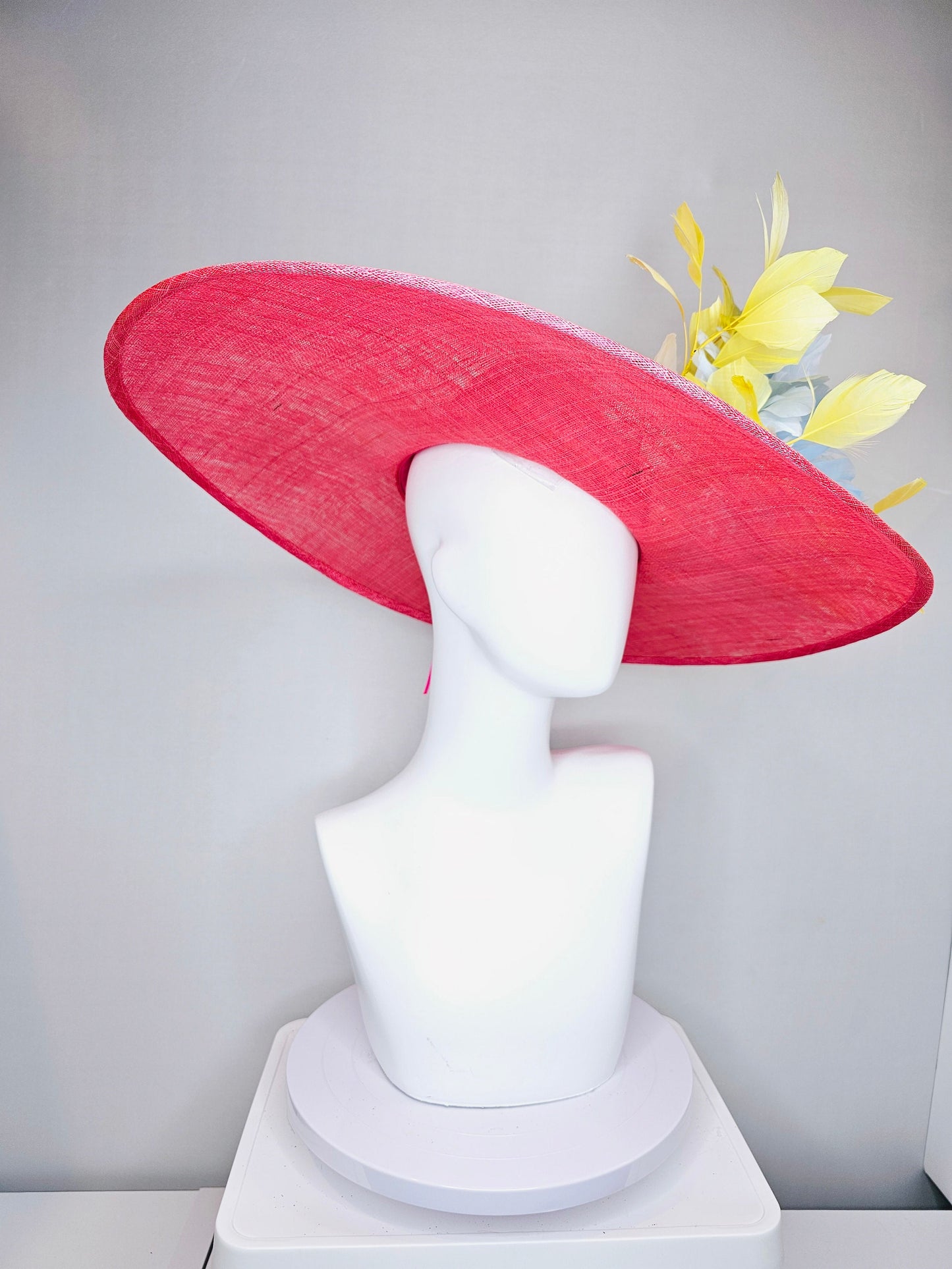 kentucky derby hat large wide brim sinamay coral pink hat with yellow feathers light blue fluffy feather flowers