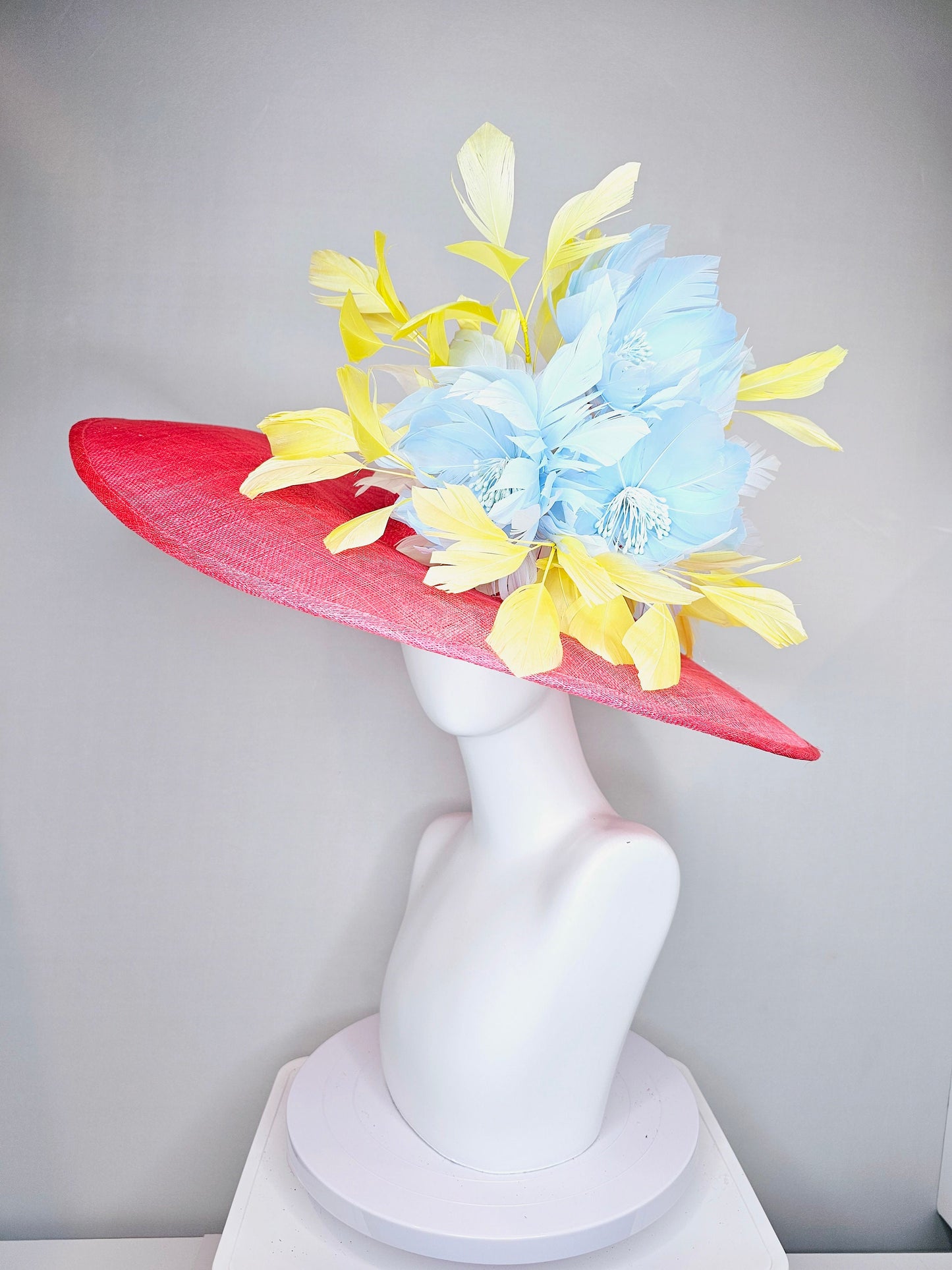 kentucky derby hat large wide brim sinamay coral pink hat with yellow feathers light blue fluffy feather flowers