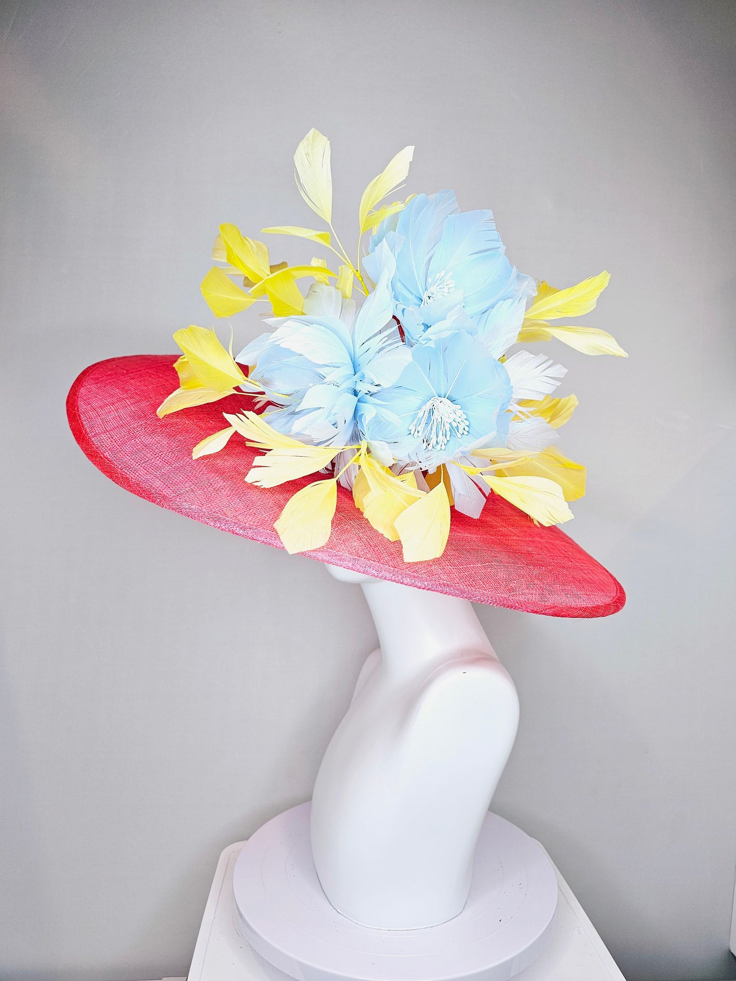 kentucky derby hat large wide brim sinamay coral pink hat with yellow feathers light blue fluffy feather flowers