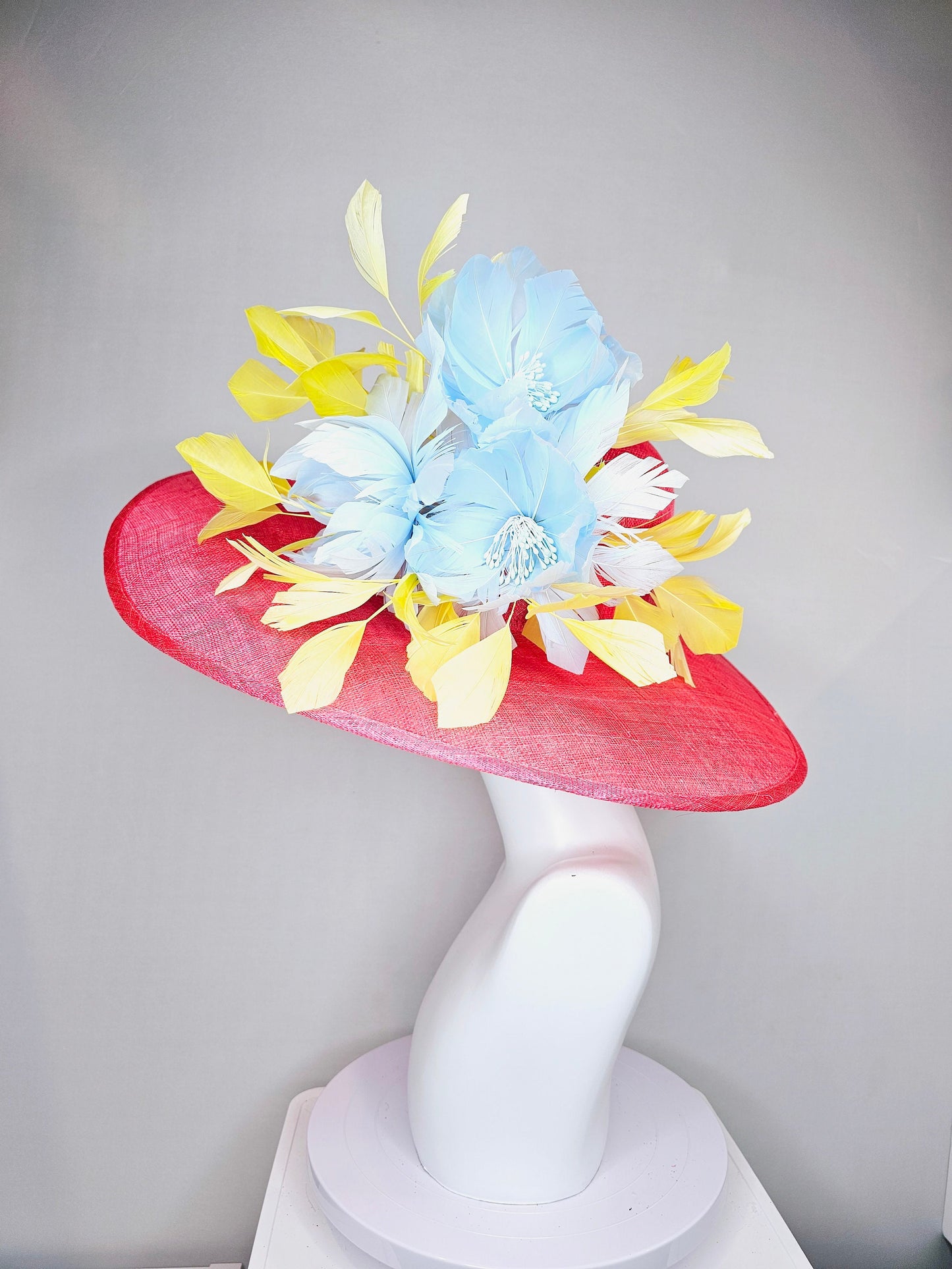 kentucky derby hat large wide brim sinamay coral pink hat with yellow feathers light blue fluffy feather flowers