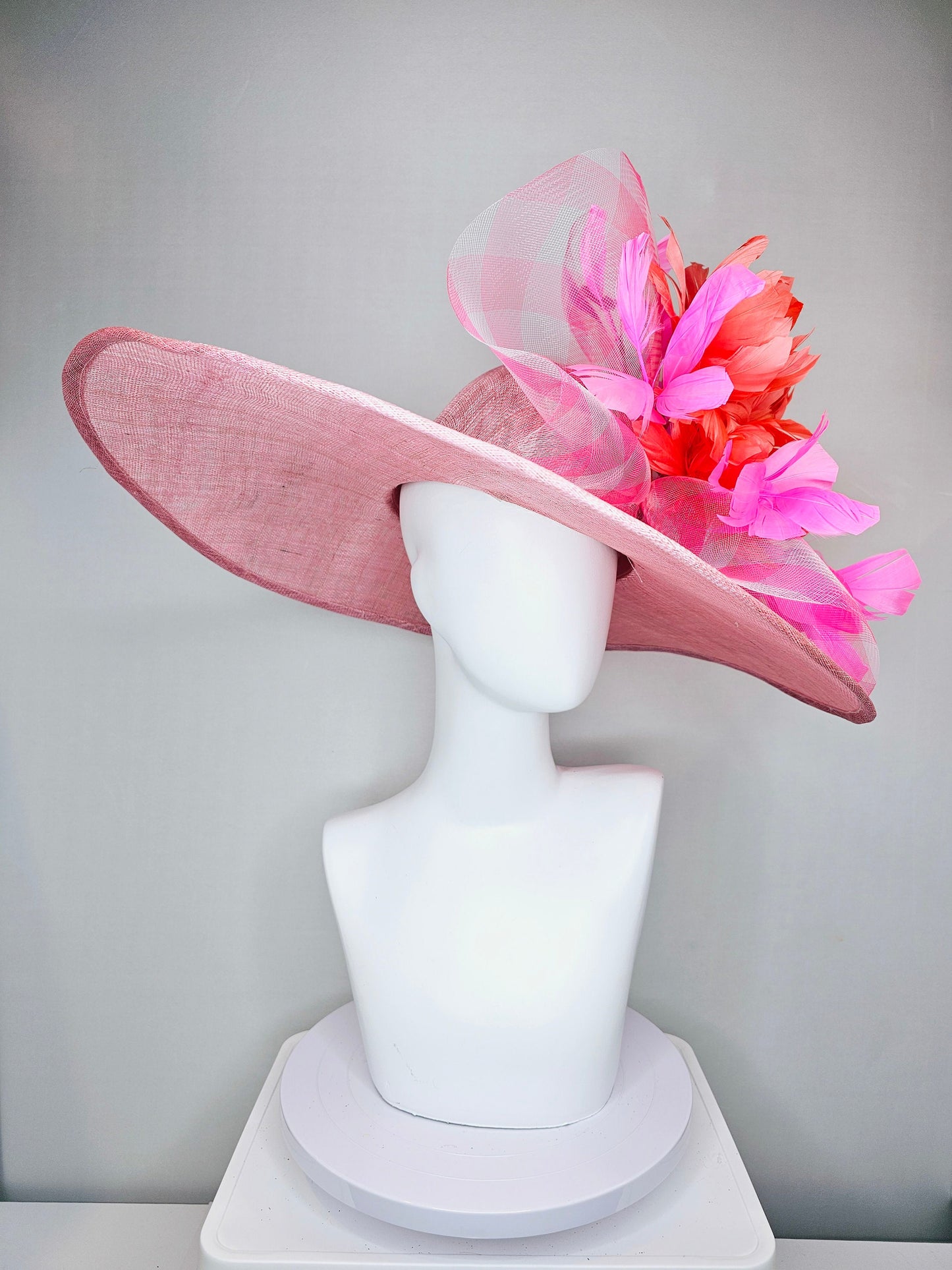kentucky derby hat large wide brim sinamay light pink hat with large pink feather orange coral feather flowers and crinoline