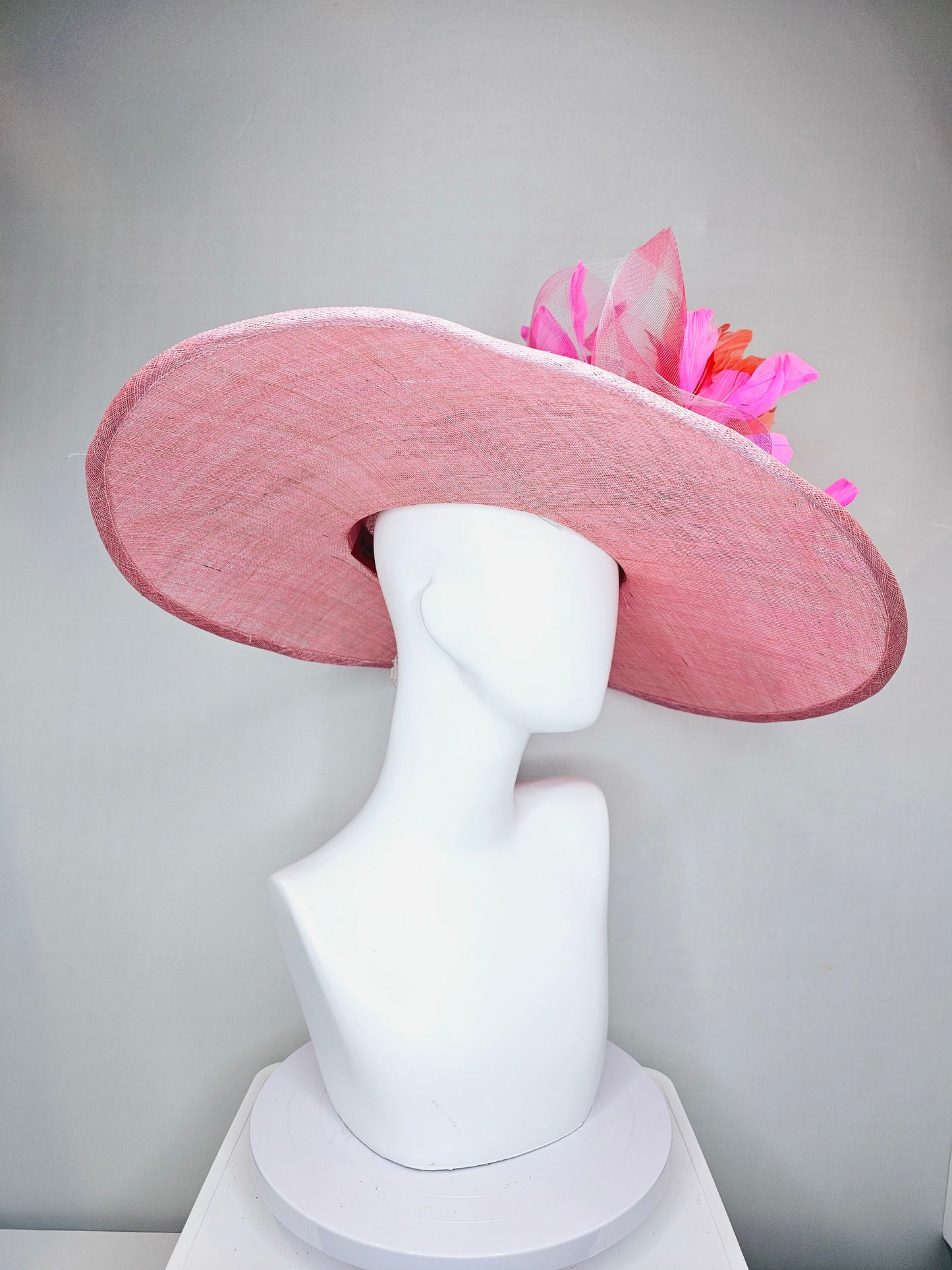 kentucky derby hat large wide brim sinamay light pink hat with large pink feather orange coral feather flowers and crinoline