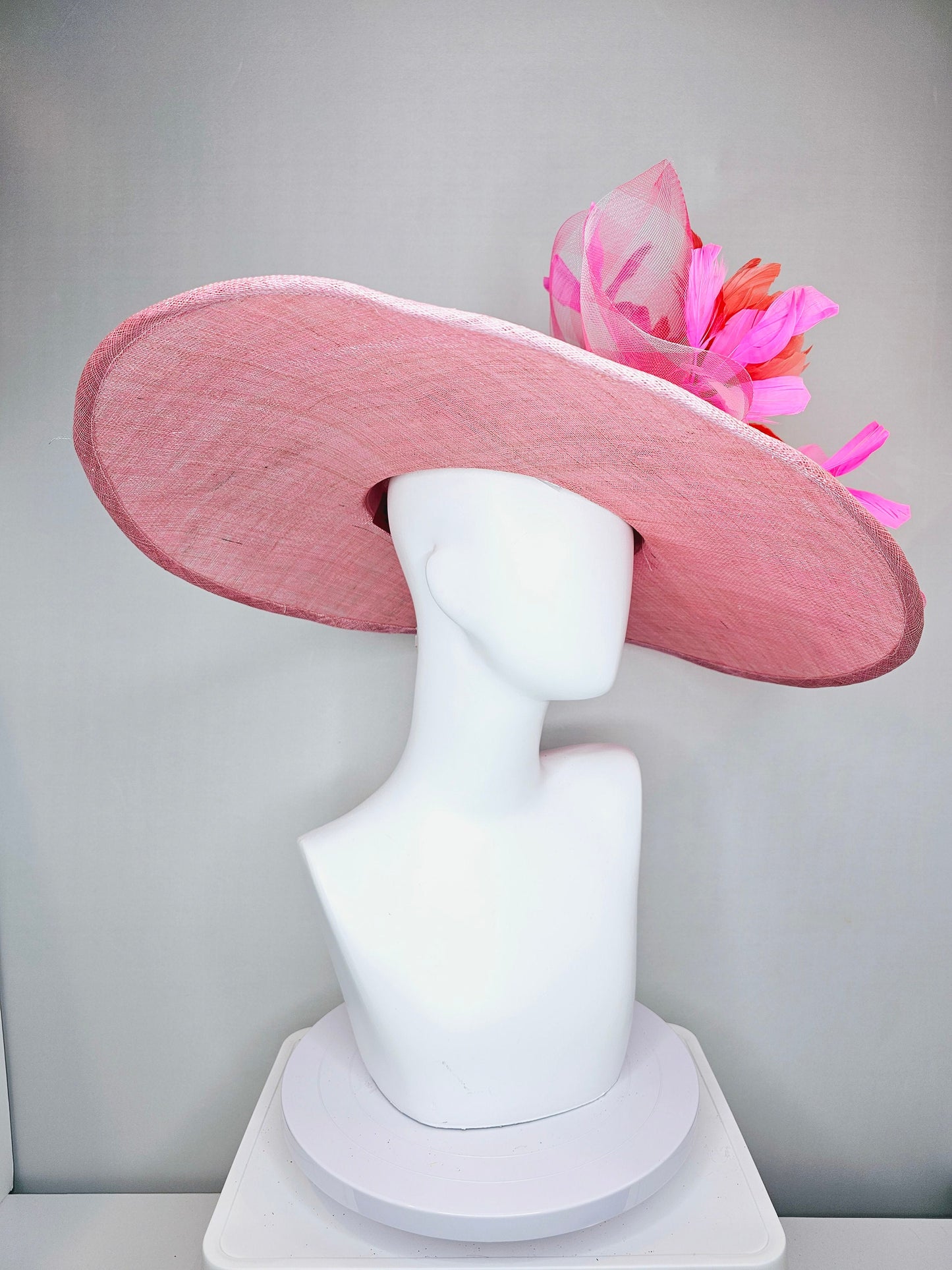 kentucky derby hat large wide brim sinamay light pink hat with large pink feather orange coral feather flowers and crinoline