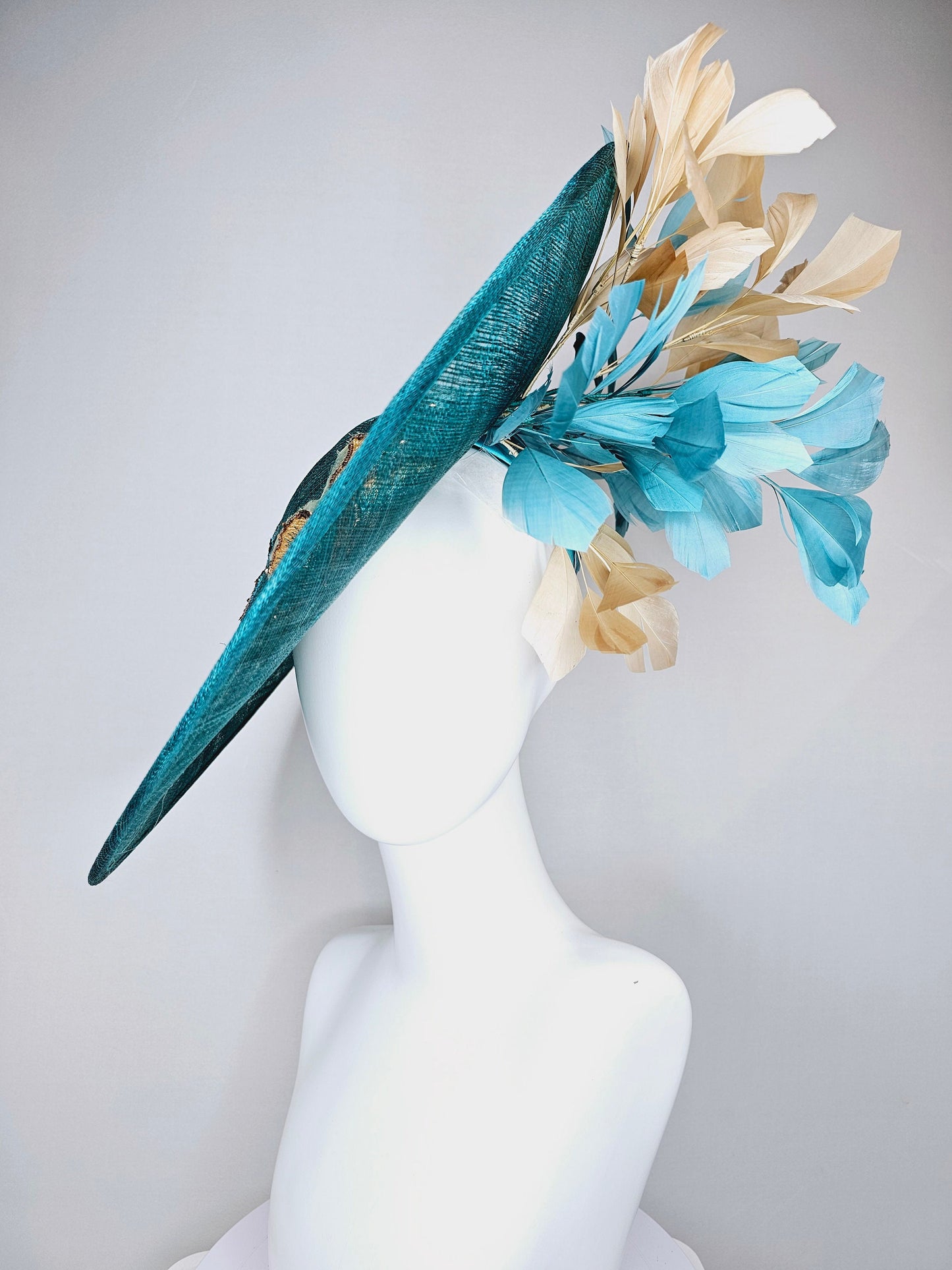 kentucky derby hat fascinator teal blue sinamay saucer with gold and teal peacock blue green feathers and teal gold embroidered flowers
