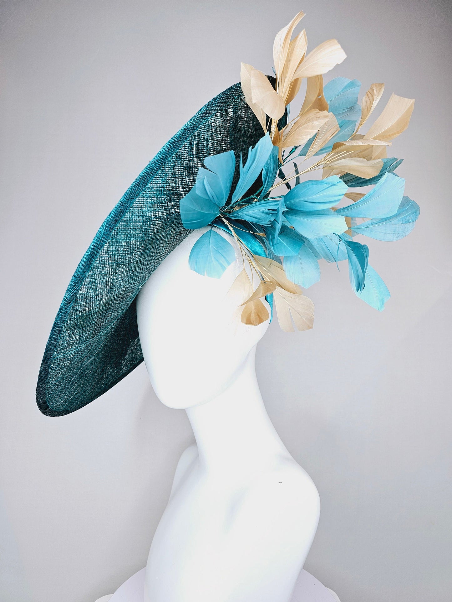 kentucky derby hat fascinator teal blue sinamay saucer with gold and teal peacock blue green feathers and teal gold embroidered flowers