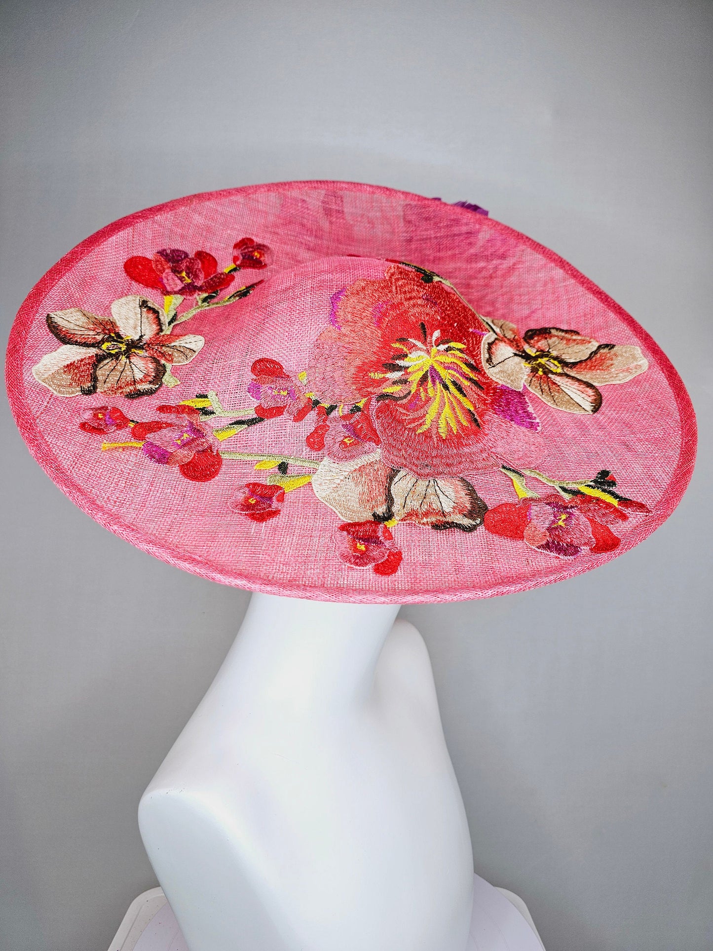 kentucky derby hat fascinator bright pink coral sinamay saucer with lavender purple coral yellow embroidered flowers purple coral feathers