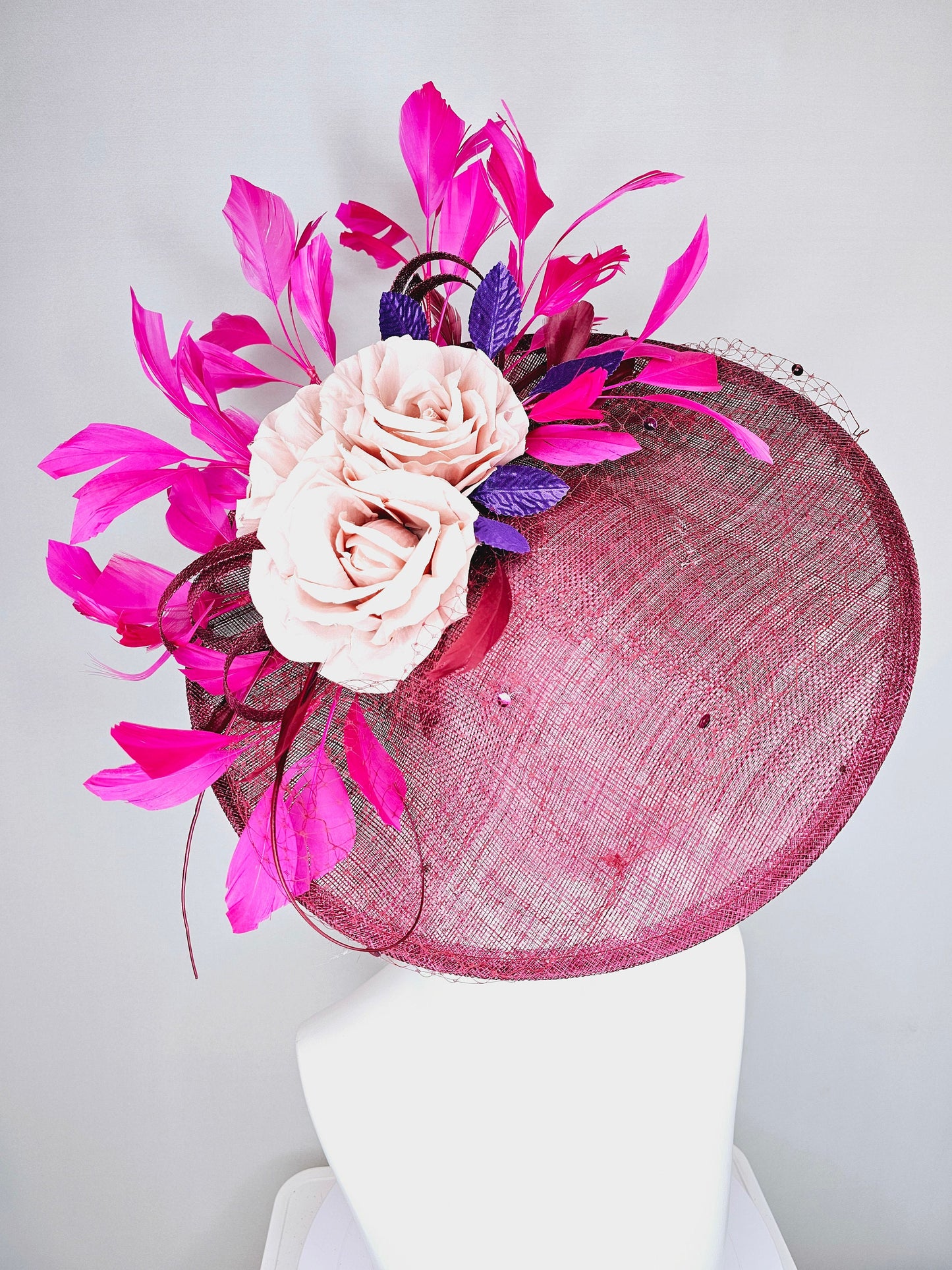 kentucky derby hat fascinator magenta maroon wine saucer with netting mauve pink flowers purple leaves and fuchsia pink feathers