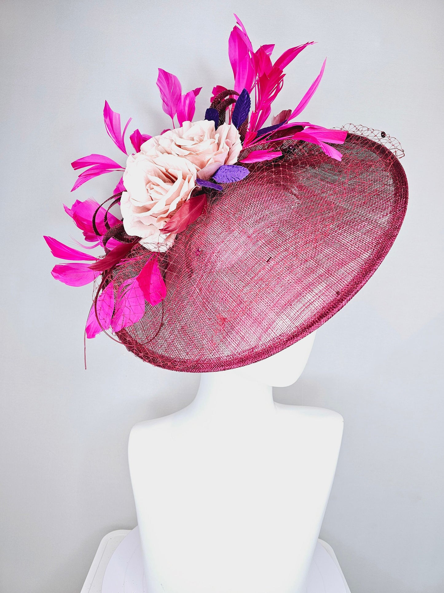 kentucky derby hat fascinator magenta maroon wine saucer with netting mauve pink flowers purple leaves and fuchsia pink feathers