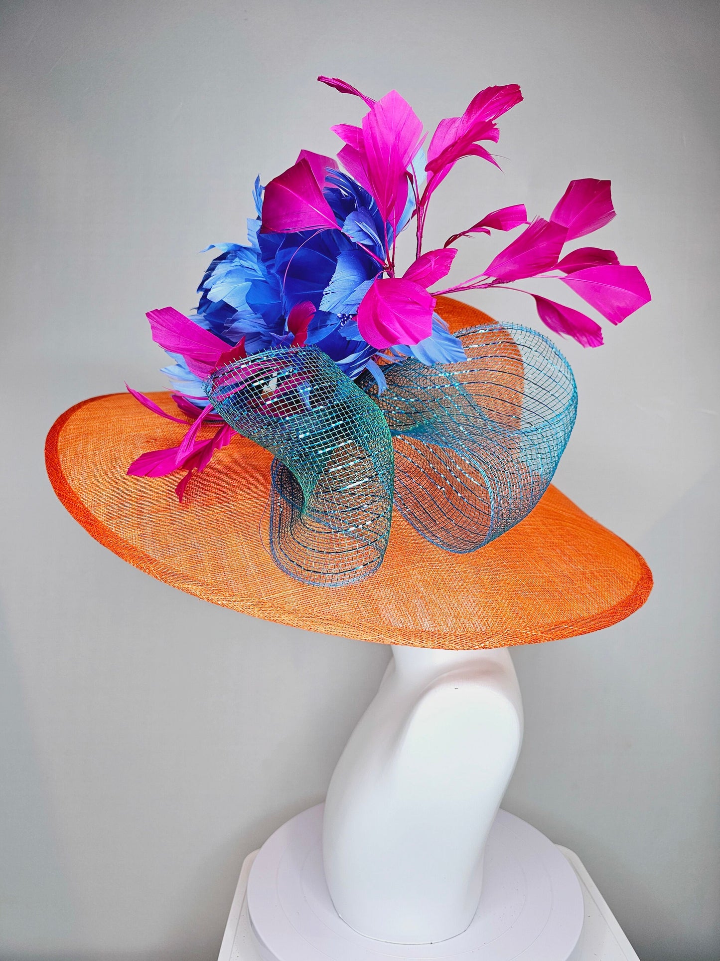 kentucky derby hat large wide brim sinamay orange hat with fuchsia pink feathers and royal blue fluffy feather flowers w teal blue crinoline