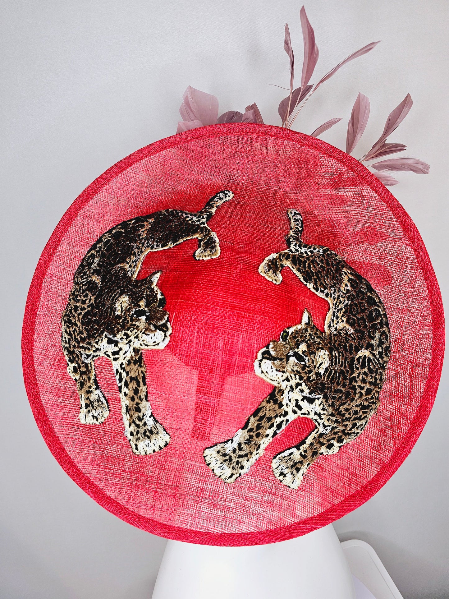 kentucky derby hat scarlet red sinamay saucer with black ivory gold leopard embroidered with blush pink feathers