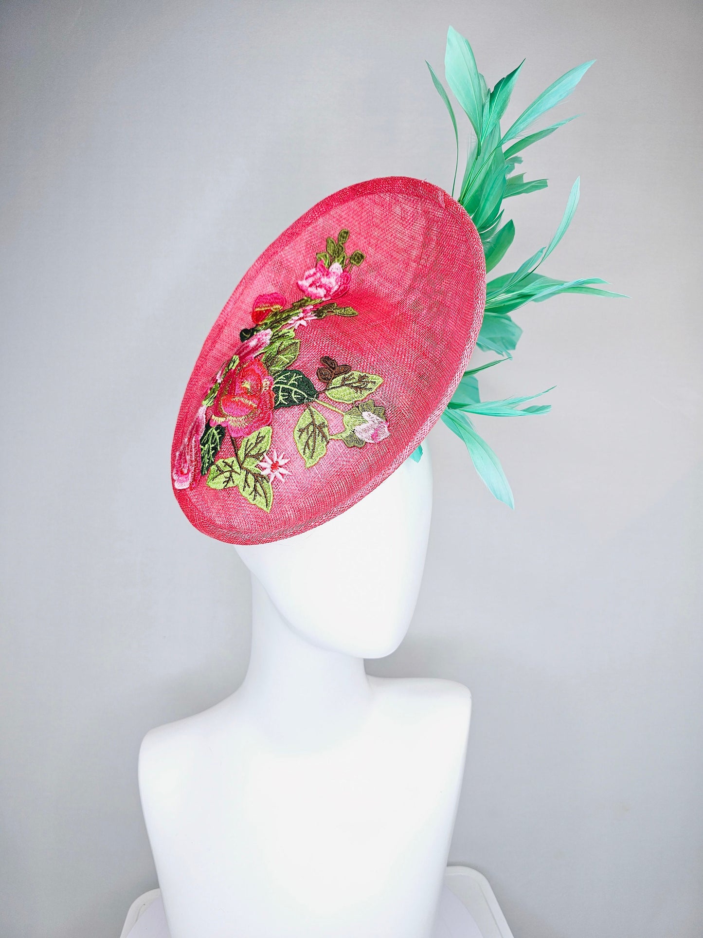 kentucky derby hat peach pink sinamay saucer with peach green gold pink embroidered flowers with green feathers