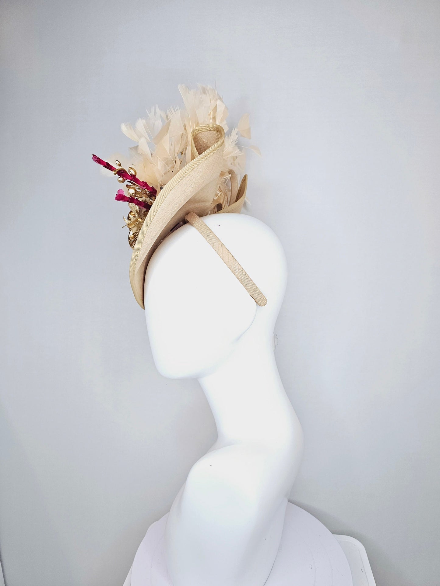 kentucky derby hat fascinator gold taupe beige shantung silk saucer with curls and gold orchids and light tan feathers with burgundy stems