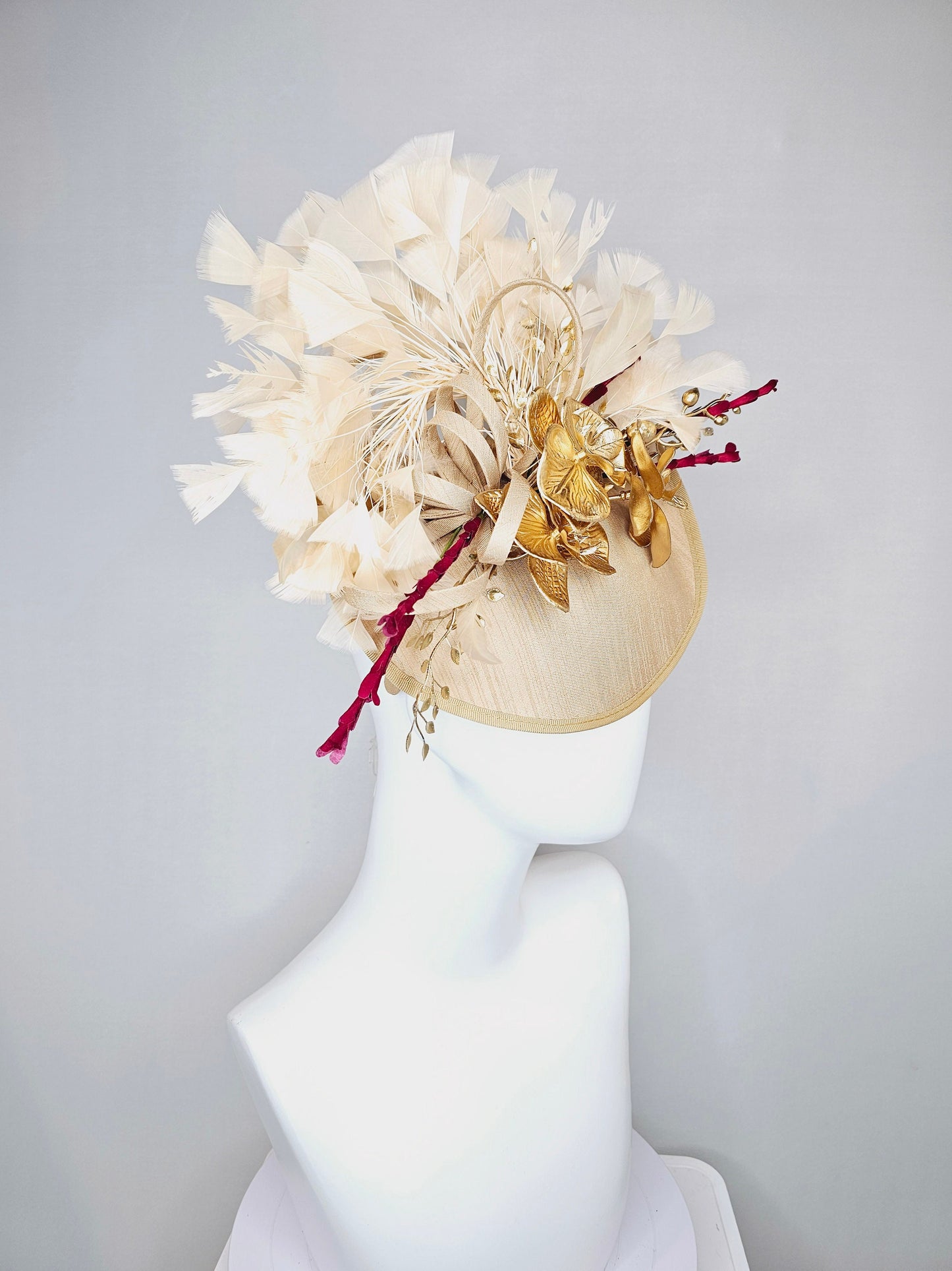 kentucky derby hat fascinator gold taupe beige shantung silk saucer with curls and gold orchids and light tan feathers with burgundy stems