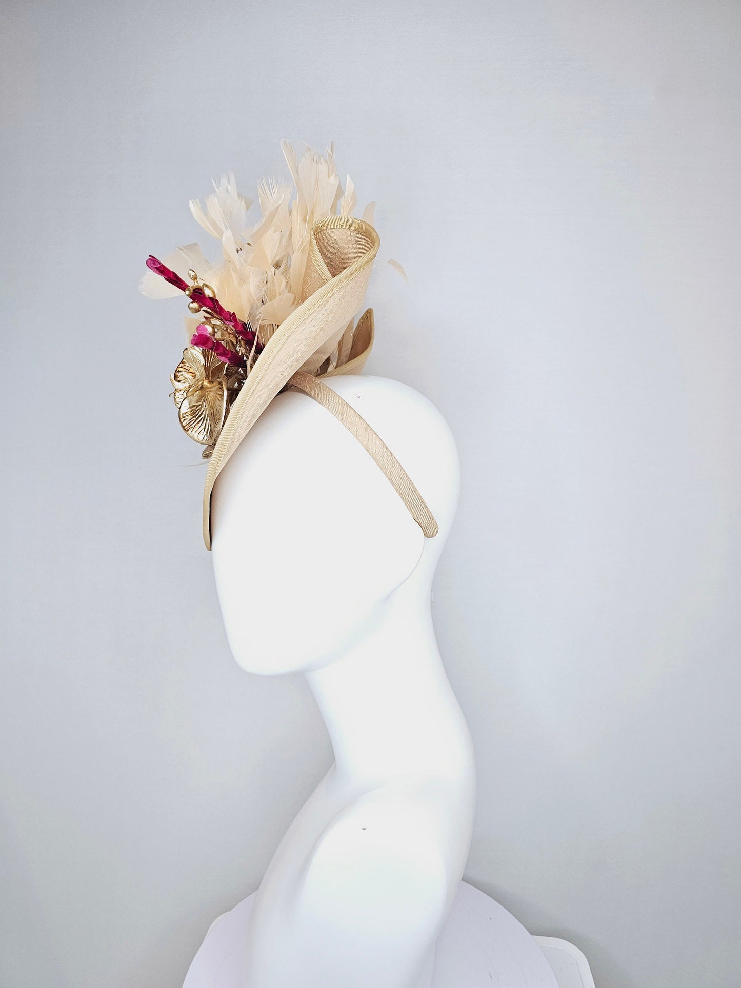 kentucky derby hat fascinator gold taupe beige shantung silk saucer with curls and gold orchids and light tan feathers with burgundy stems